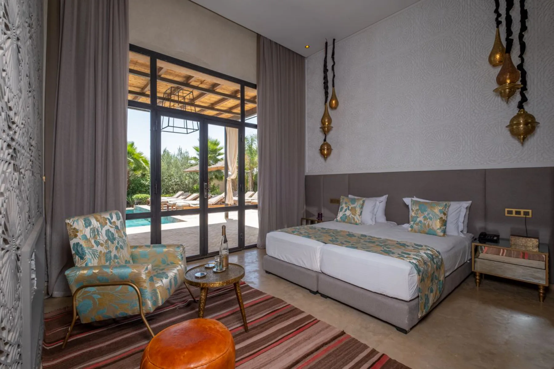 Villa Kallista, 12 bedroom wedding and event villa in Marrakech, bedroom opening onto the pool. The Marrakech Curator.