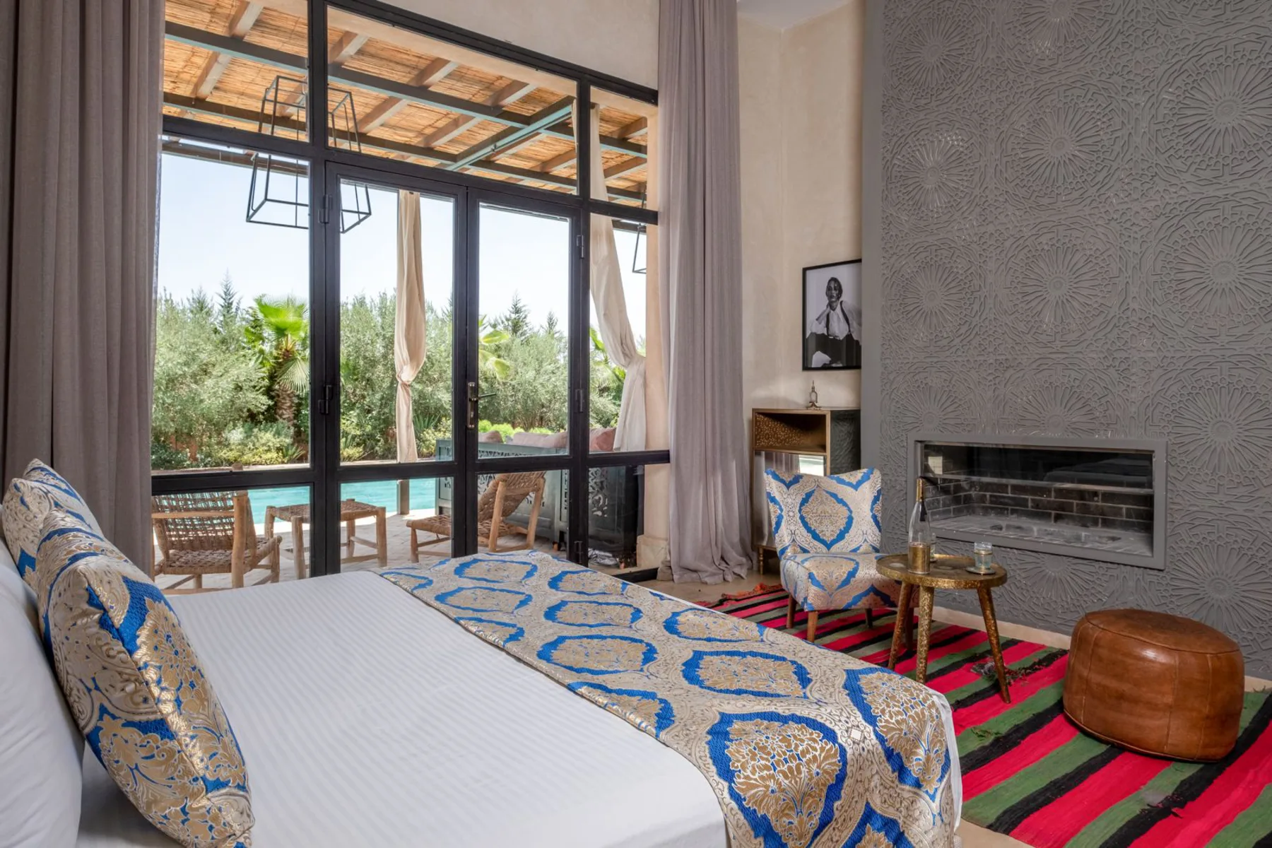 Villa Kallista, 12 bedroom wedding and event villa in Marrakech, suite with fireplace and pool view. The Marrakech Curator.