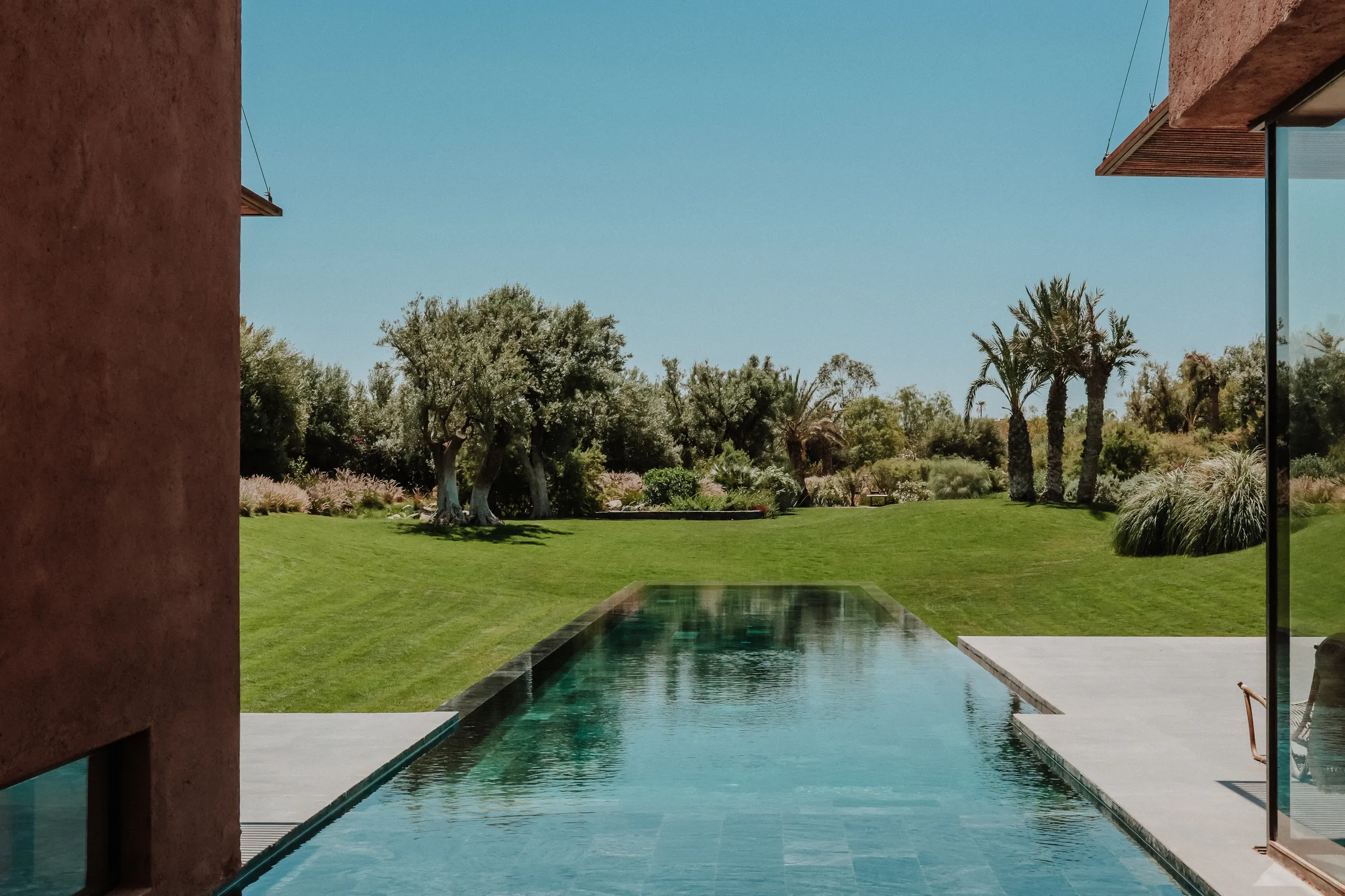 Villa Kalliope, private villa rental in the Palmeraie, Marrakech: pool terrace opening onto the garden