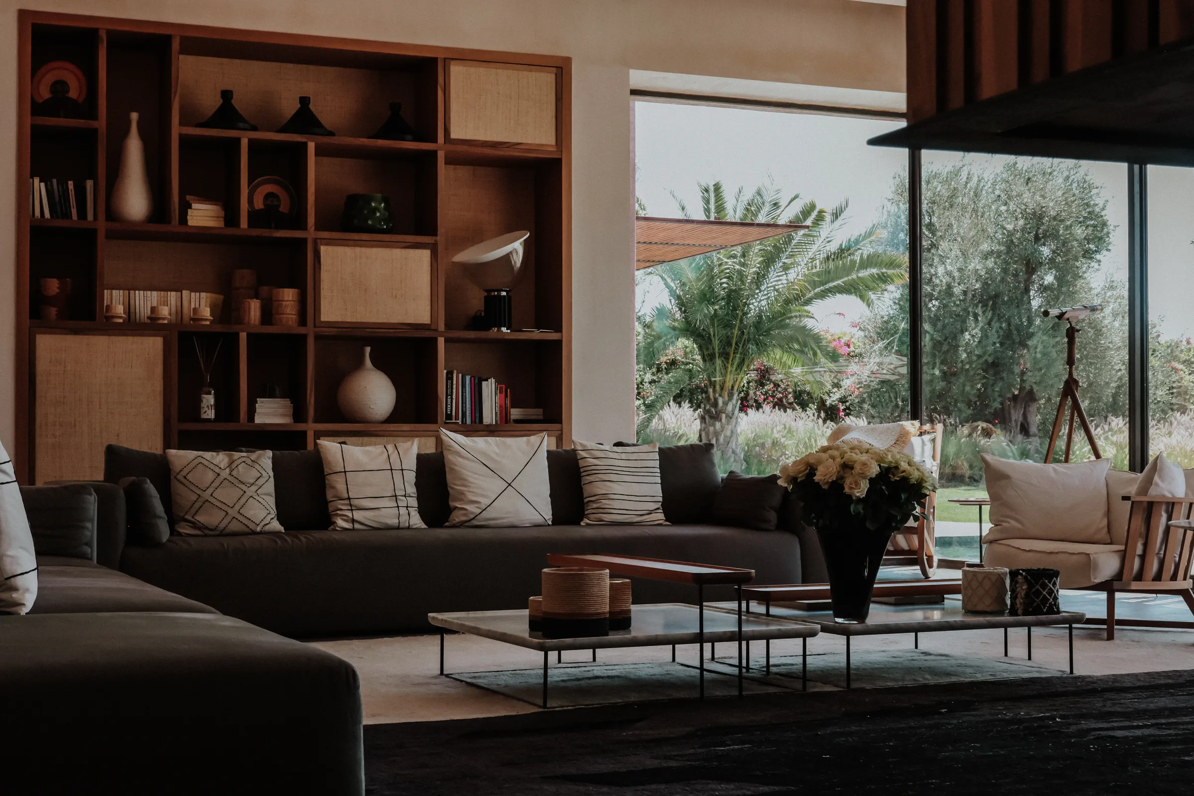 Villa Kalliope, private villa rental in the Palmeraie, Marrakech: living room with library and garden view