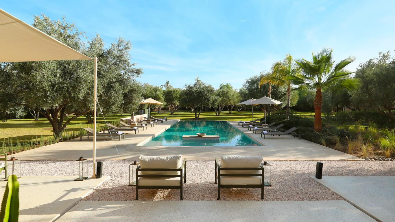 Villa Eos, private villa rental in the Palmeraie, Marrakech: pool with sun loungers and parasols