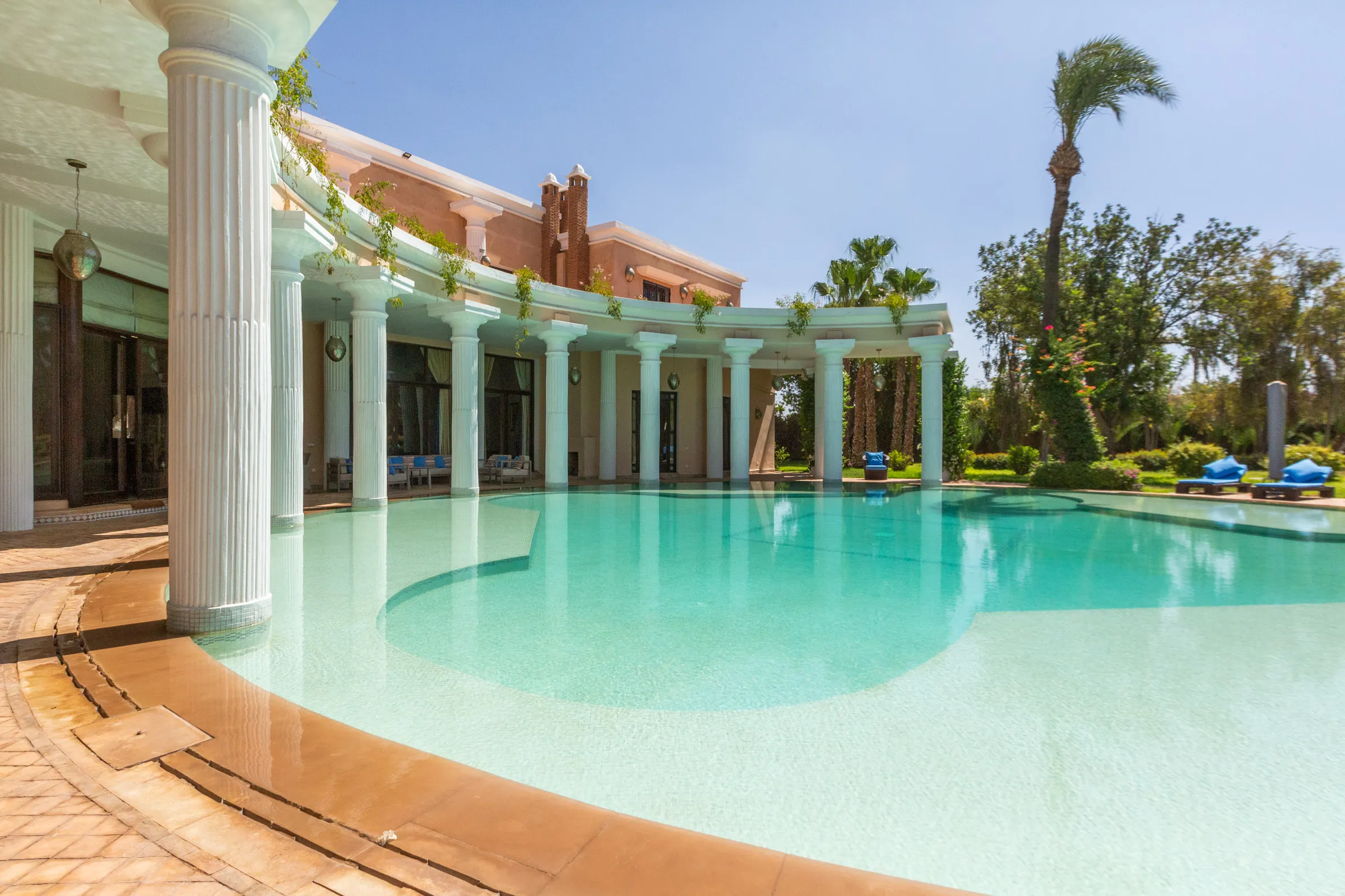 Villa Aegea, private villa rental in the Palmeraie, Marrakech: curved pool and colonnade