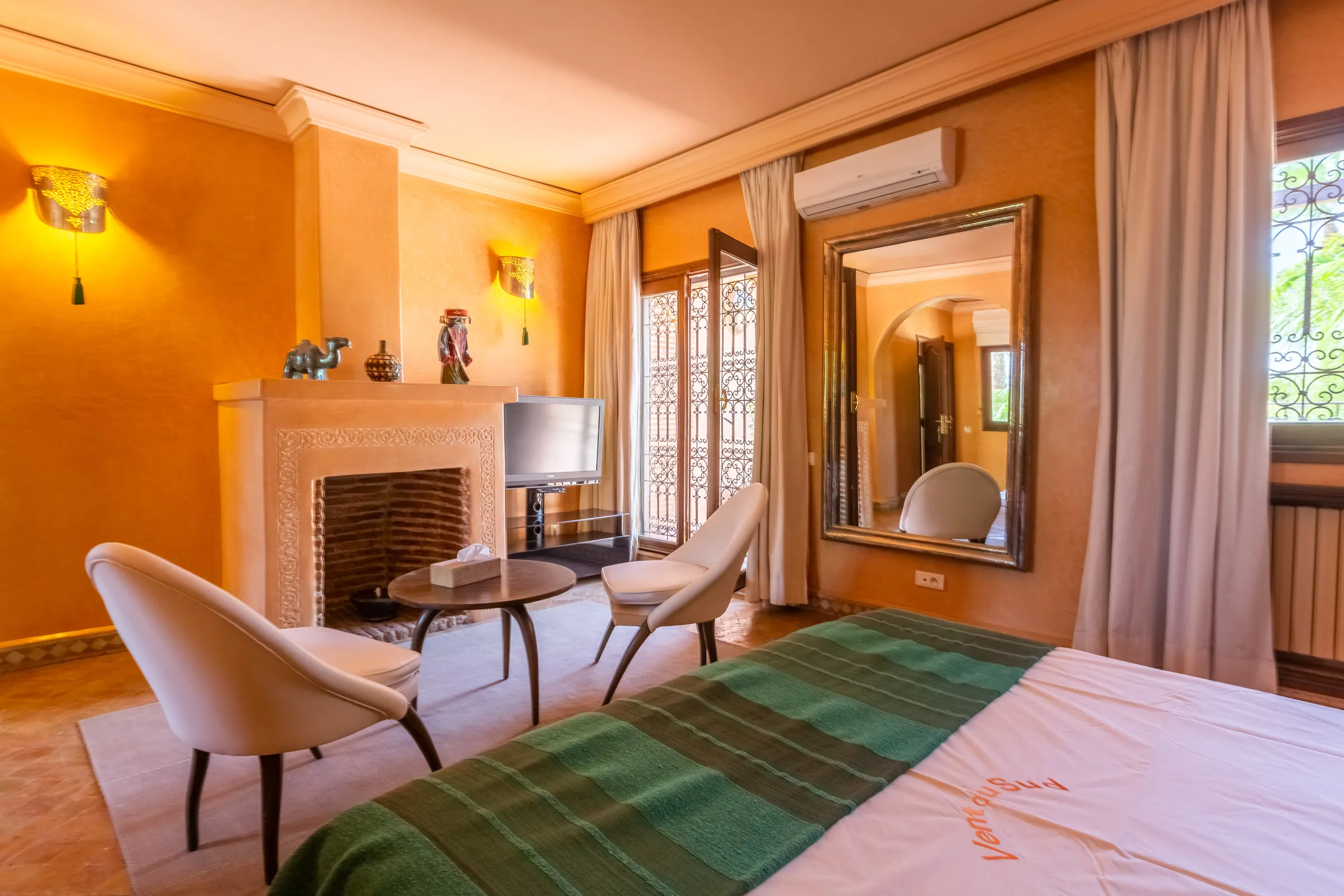 Villa Aegea, private villa rental in the Palmeraie, Marrakech: orange suite with fireplace