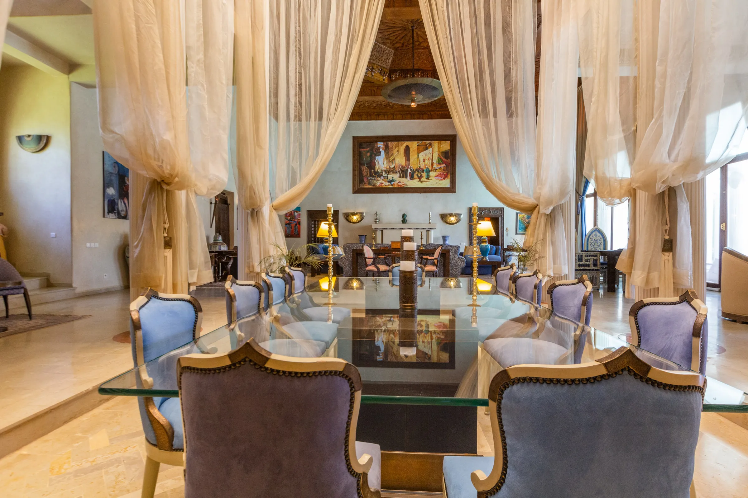 Villa Aegea, private villa rental in the Palmeraie, Marrakech: living and dining area under flowing curtains