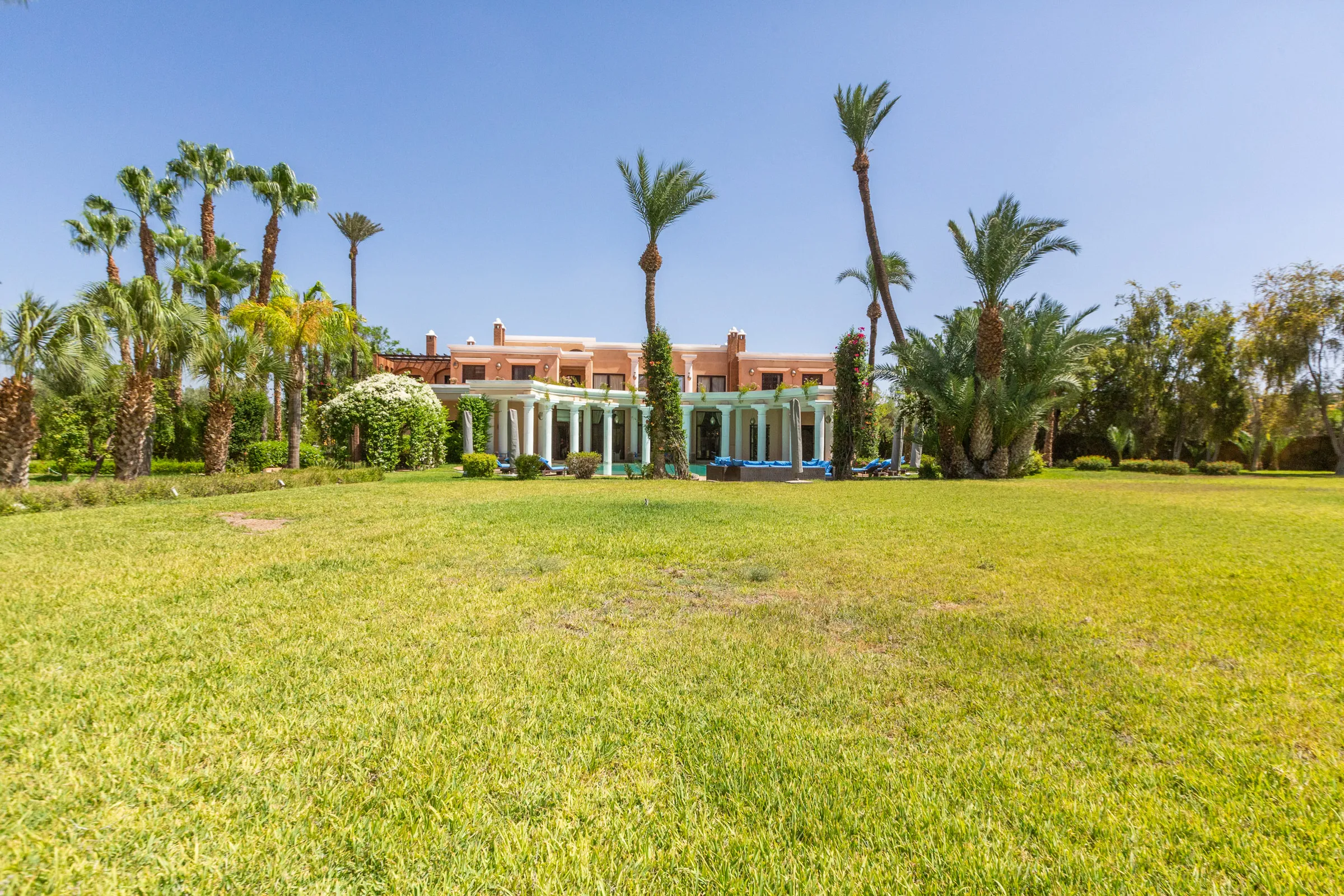 Villa Aegea, private villa rental in the Palmeraie, Marrakech: the villa beyond the lawn
