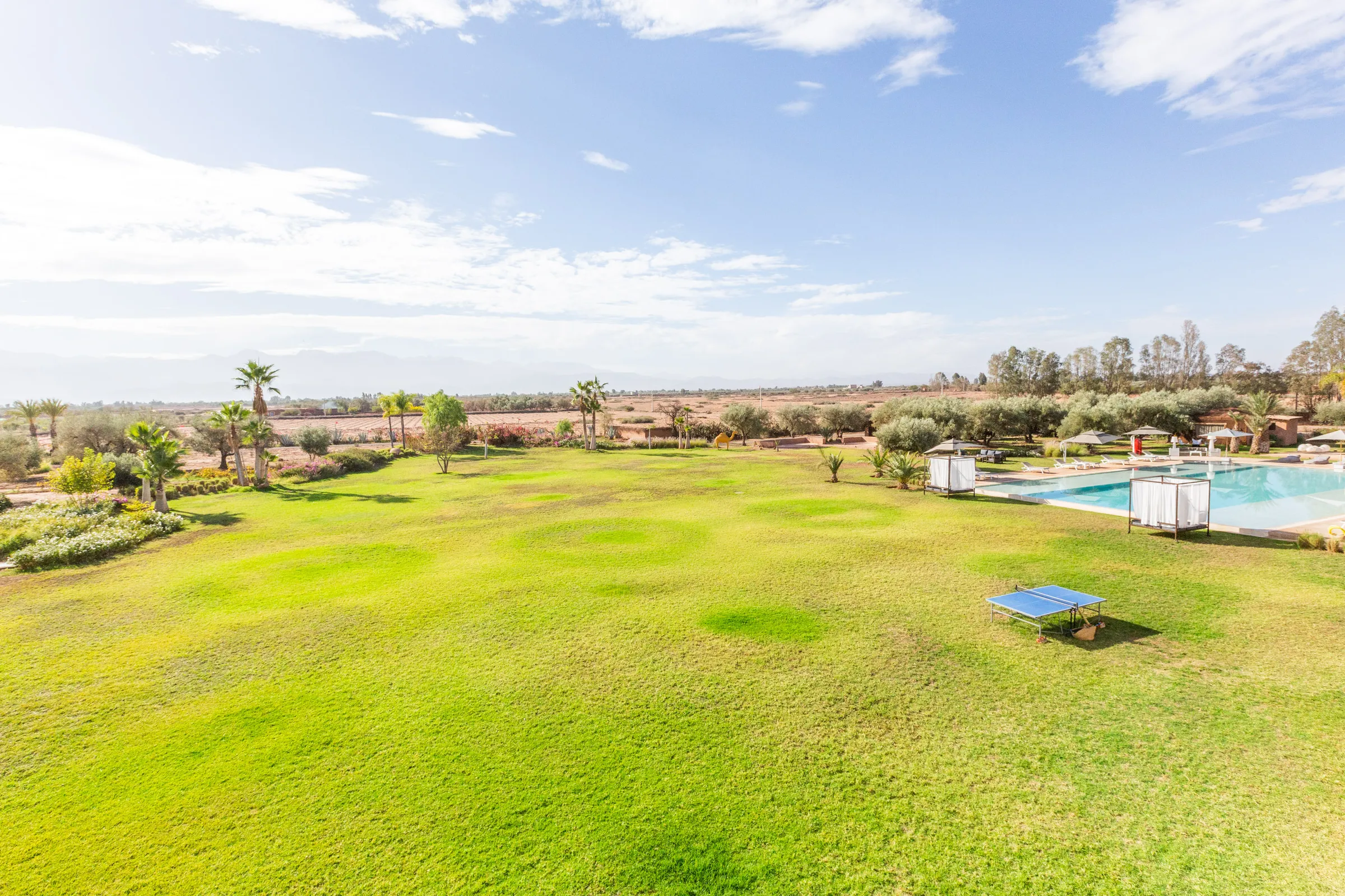 Villa Chloé, private estate rental in Sidi Abdellah Ghiat, Marrakech: estate lawns and pool facing the Atlas
