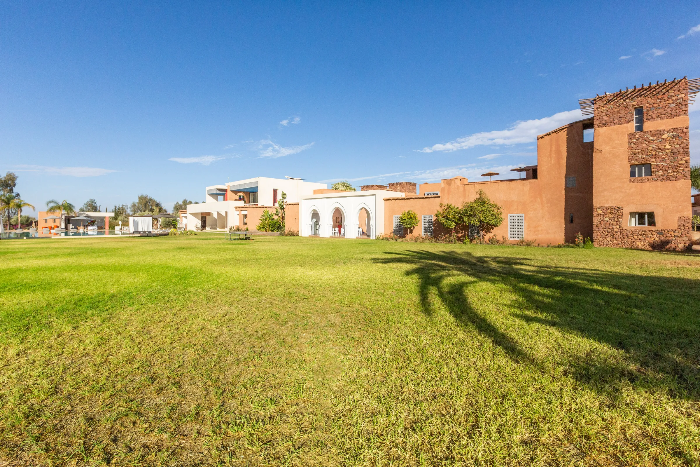 Villa Chloé, private estate rental in Sidi Abdellah Ghiat, Marrakech: the kasbah beyond the lawns