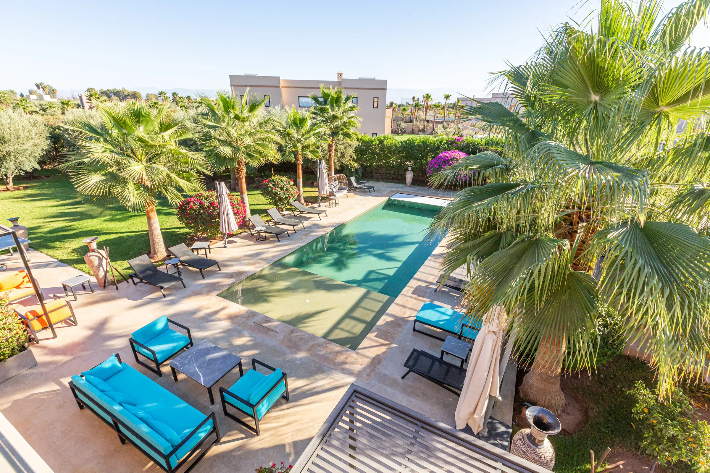 Villa Maia, private villa rental on the Route de Fès, Marrakech: pool with sun loungers among palm trees