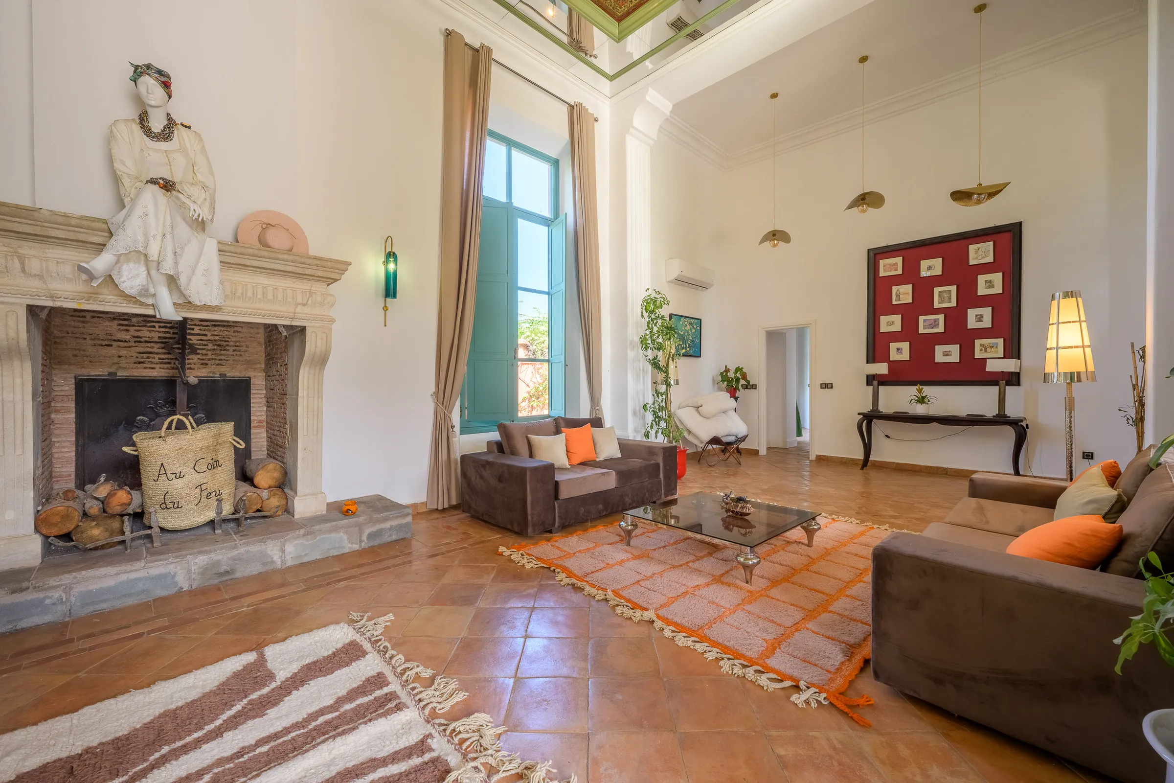 Villa Calypso, private villa rental in the Palmeraie, Marrakech: living room with stone fireplace