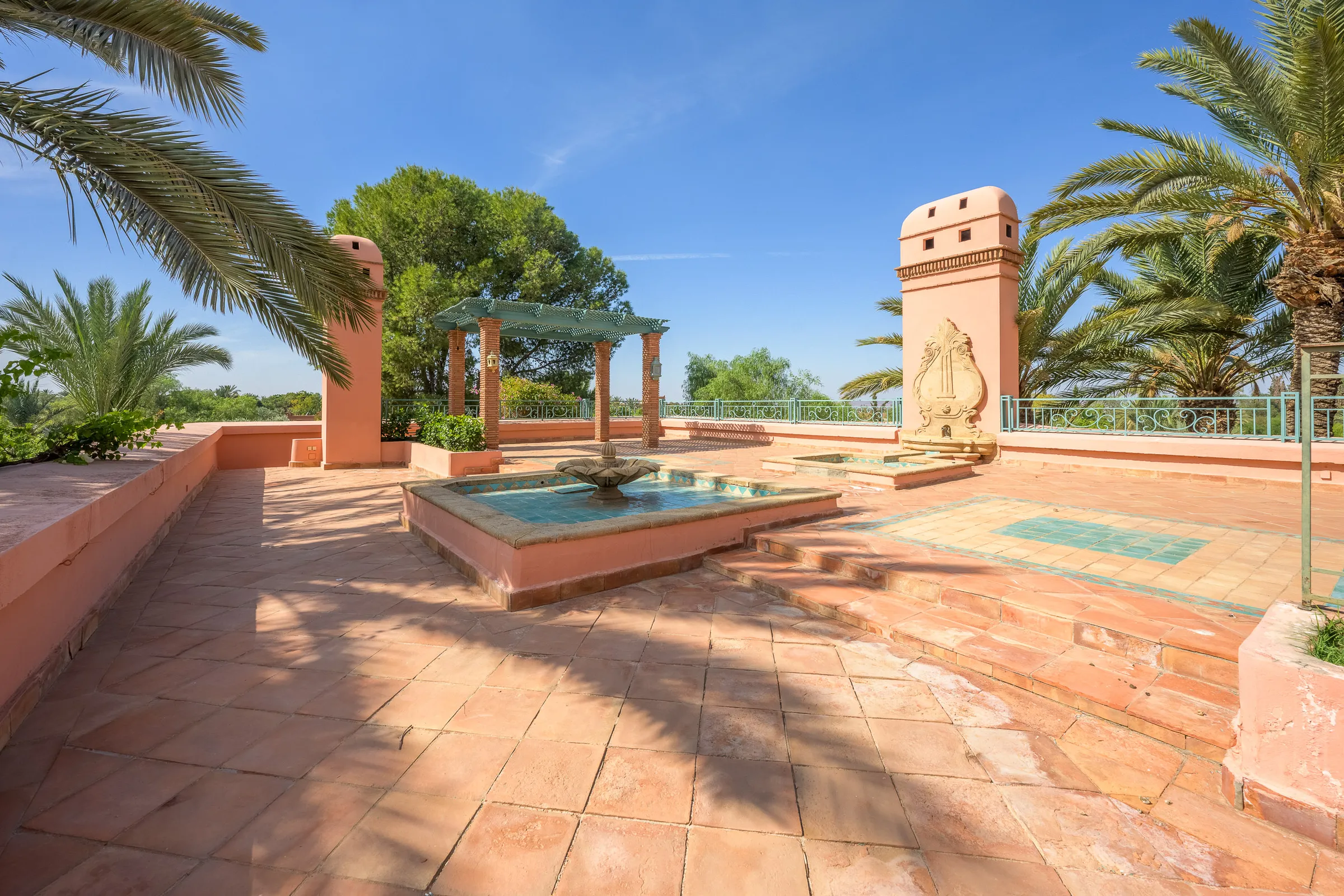 Villa Calypso, private villa rental in the Palmeraie, Marrakech: roof terrace with fountain and palm trees