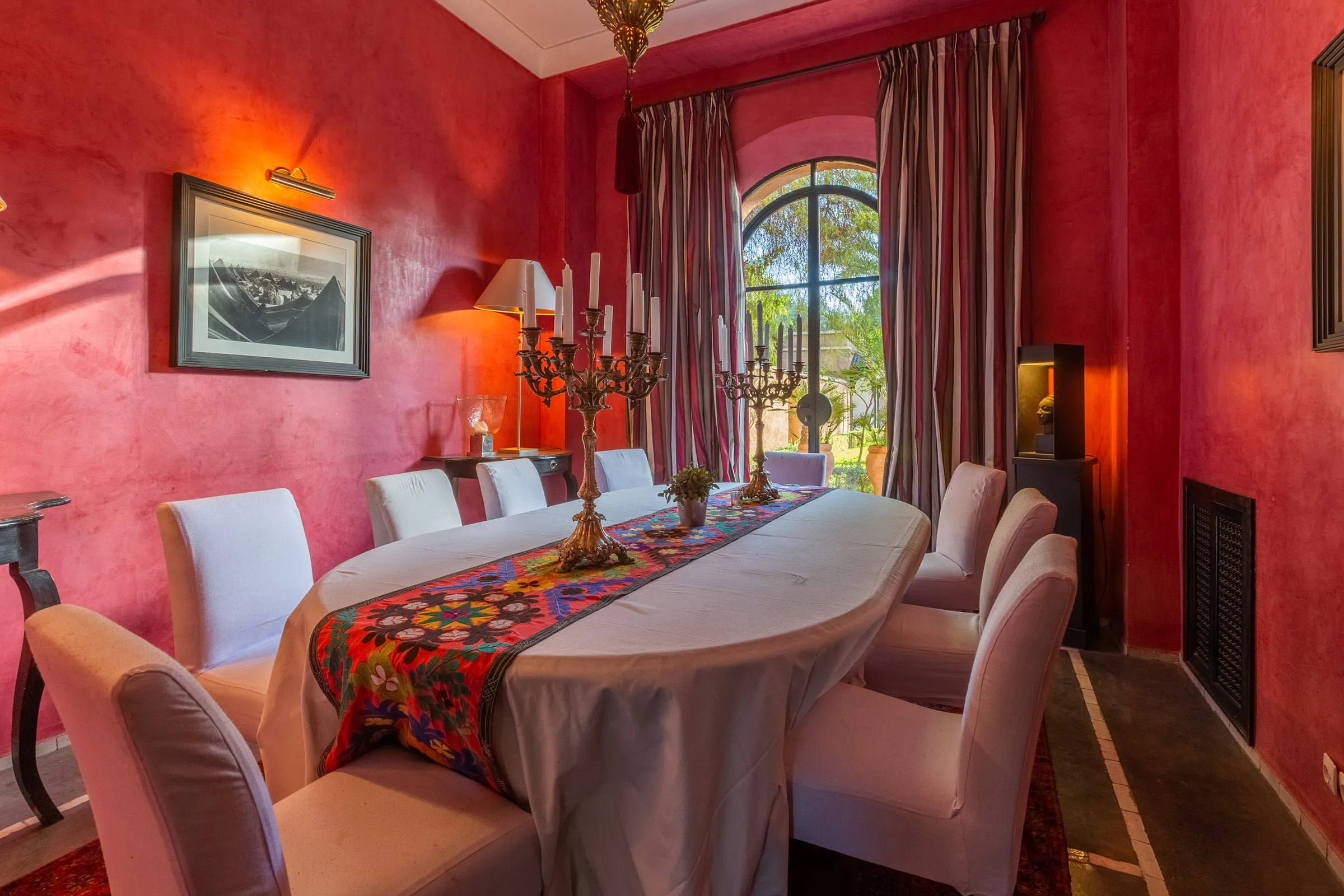 Villa Amalthea, private villa rental in the Palmeraie, Marrakech: red dining room with candelabra