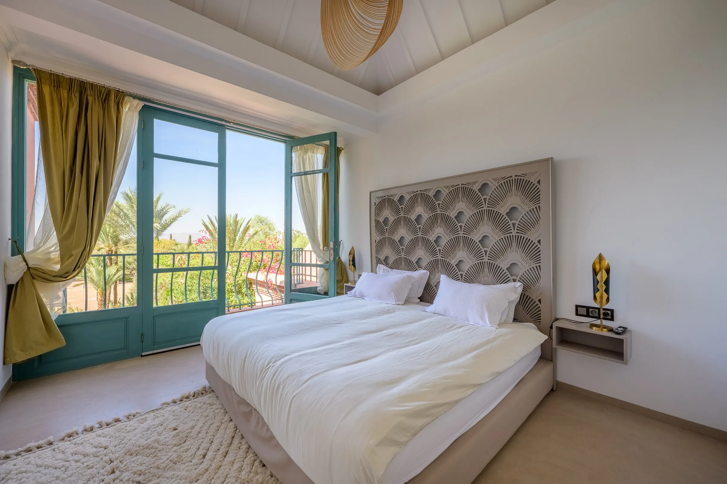 Villa Calypso, private villa rental in the Palmeraie, Marrakech: bright bedroom with view over the palm trees