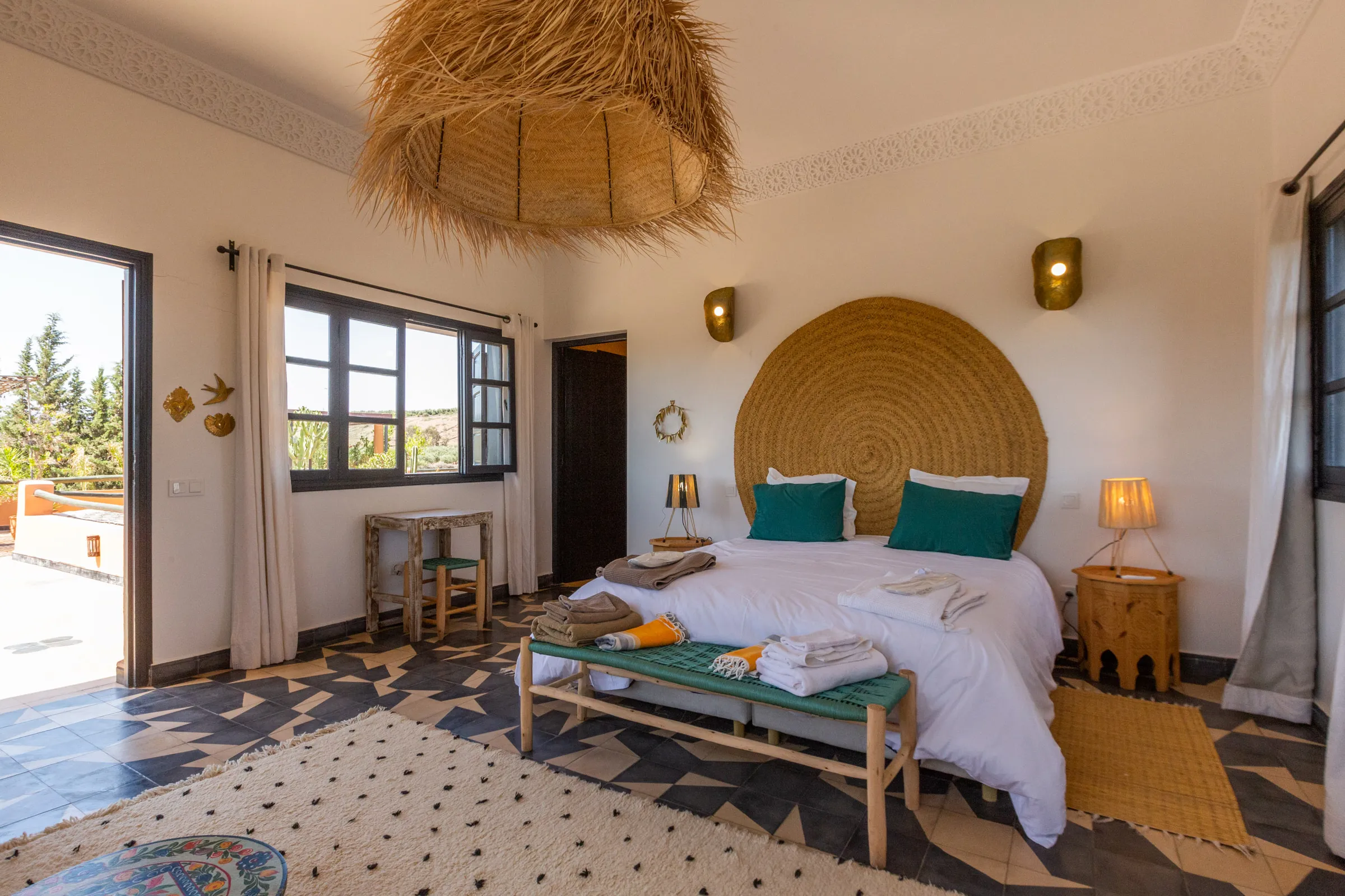 Villa Cassia, private villa rental on the Route de Tahanaout, Marrakech: bedroom with woven headboard opening onto the terrace