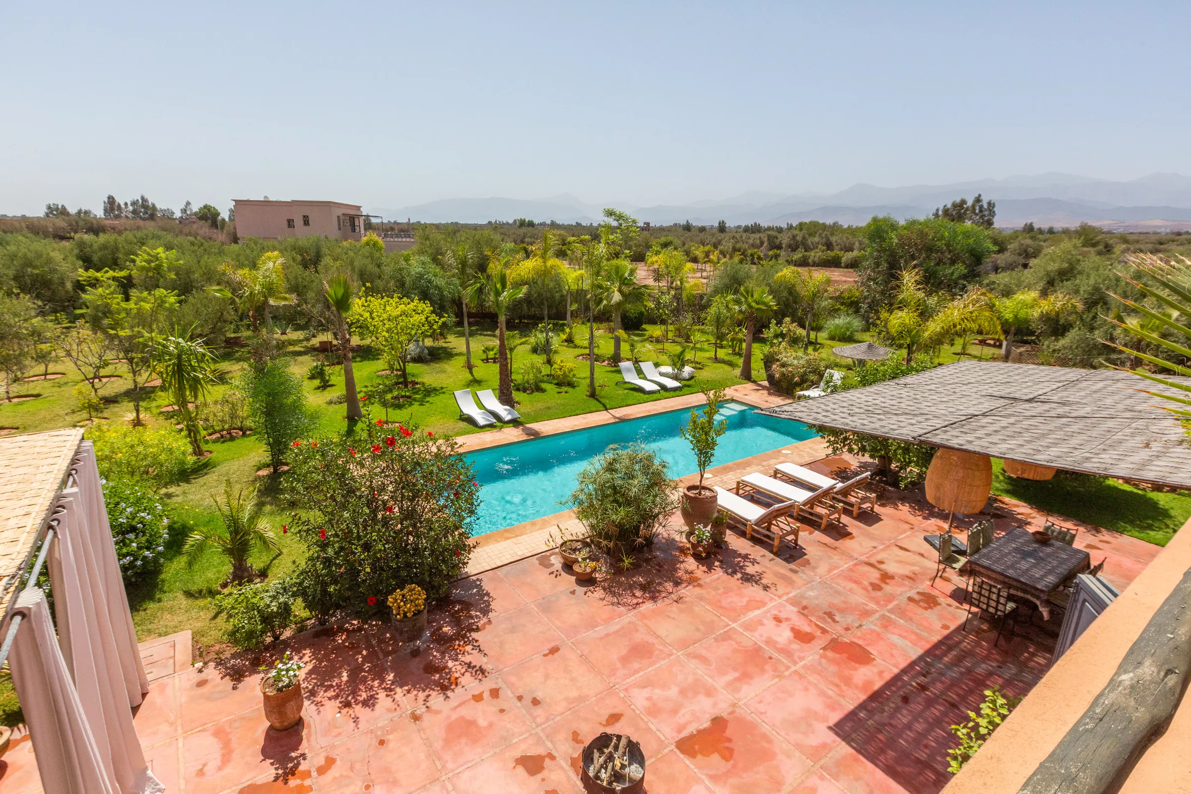 Villa Cassia, private villa rental on the Route de Tahanaout, Marrakech: view over the pool and gardens from the terrace