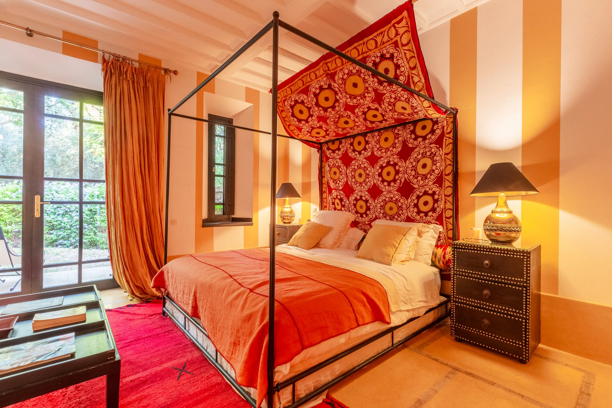 Villa Amalthea, private villa rental in the Palmeraie, Marrakech: bedroom with four-poster bed and embroidered hanging