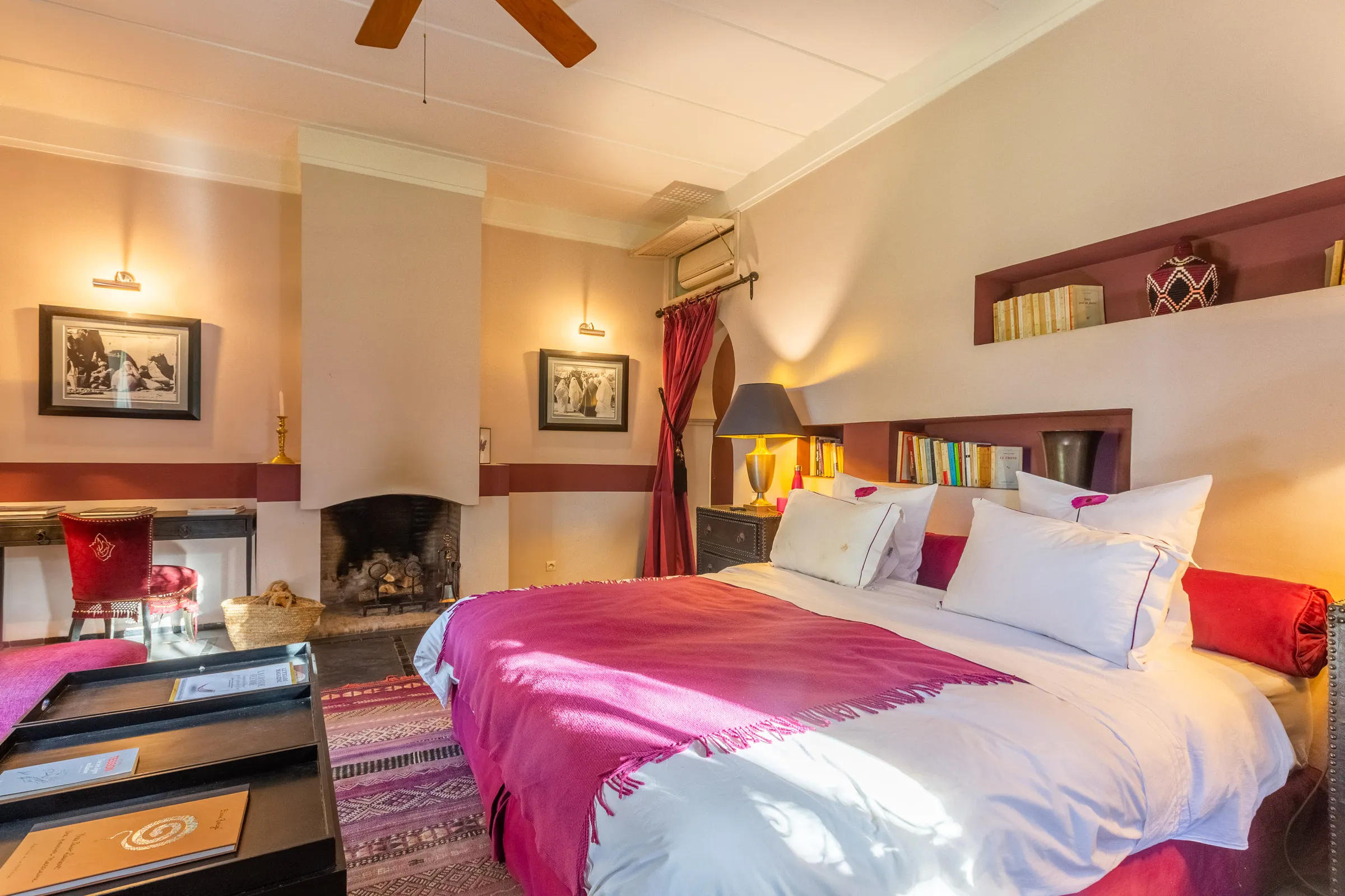 Villa Amalthea, private villa rental in the Palmeraie, Marrakech: bedroom with pink bedspread and fireplace