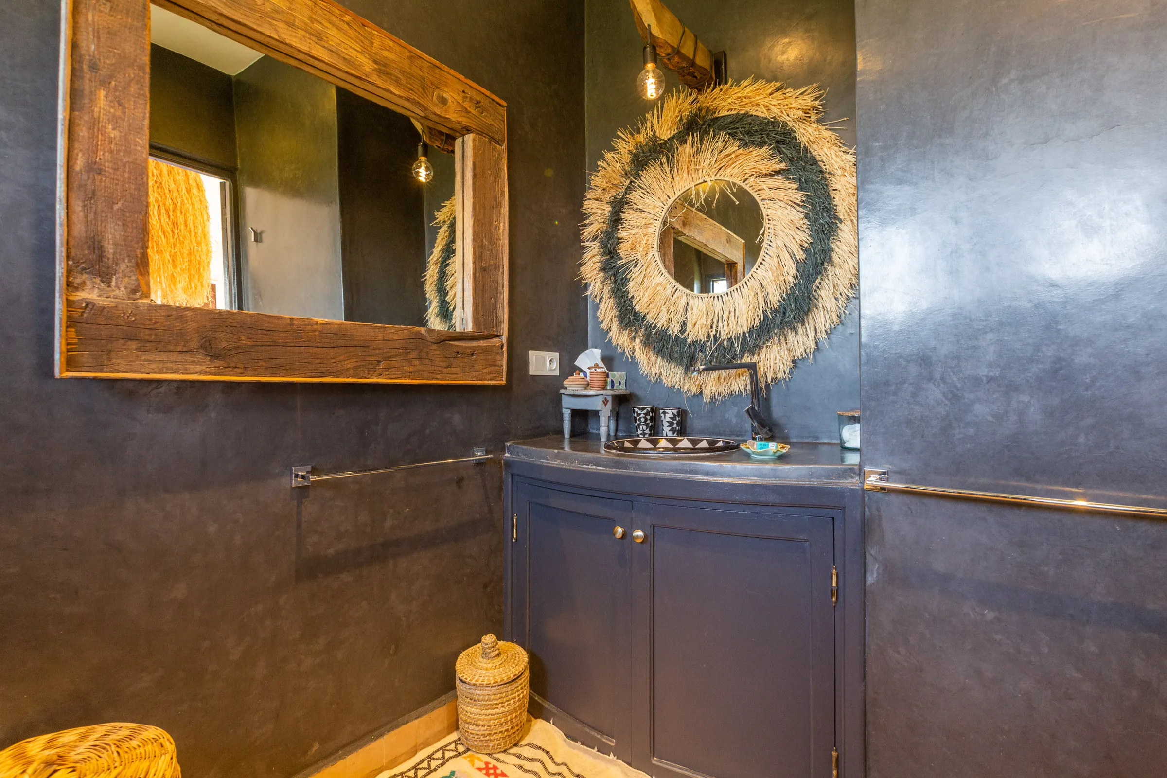 Villa Cassia, private villa rental on the Route de Tahanaout, Marrakech: bathroom with dark walls and wooden mirror