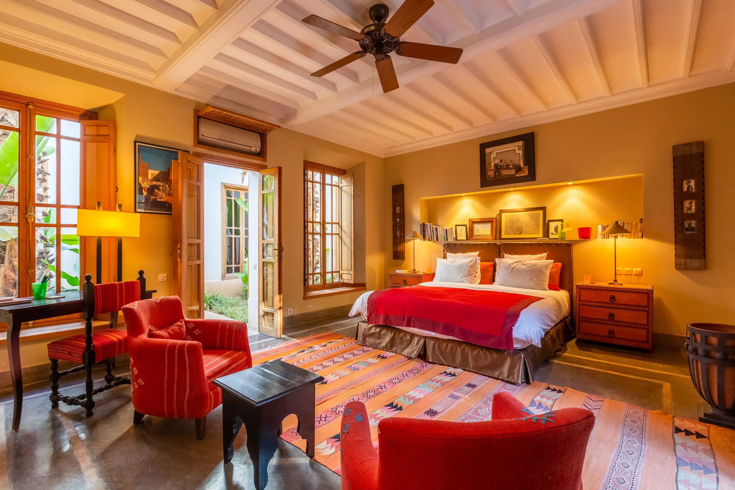 Villa Amalthea, private villa rental in the Palmeraie, Marrakech: bedroom with red armchairs and desk