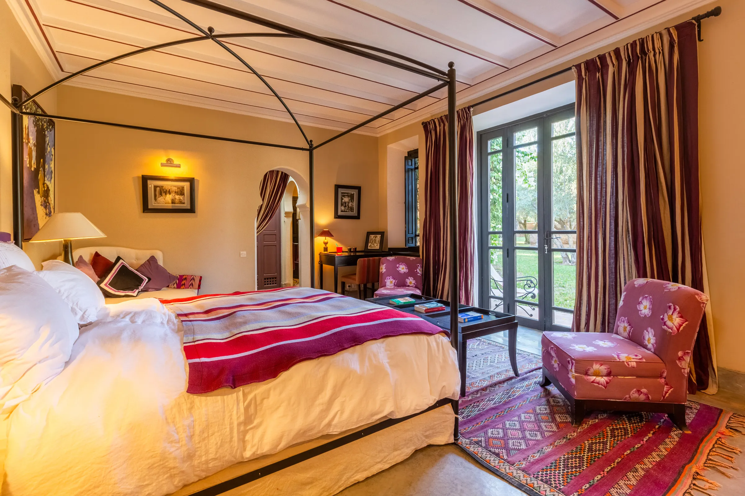 Villa Amalthea, private villa rental in the Palmeraie, Marrakech: bedroom with iron four-poster bed