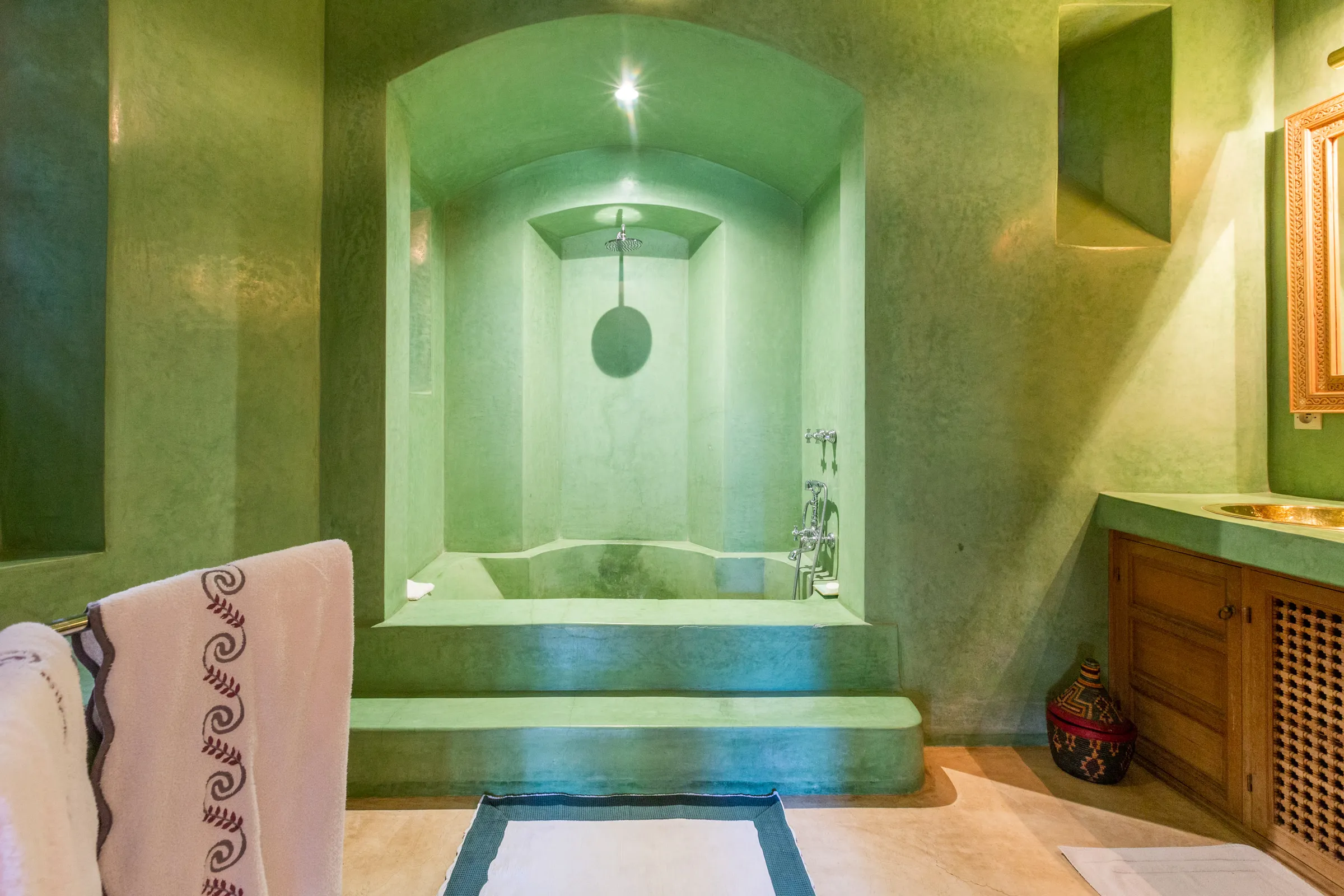 Villa Amalthea, private villa rental in the Palmeraie, Marrakech: green tadelakt bathroom with alcove bathtub