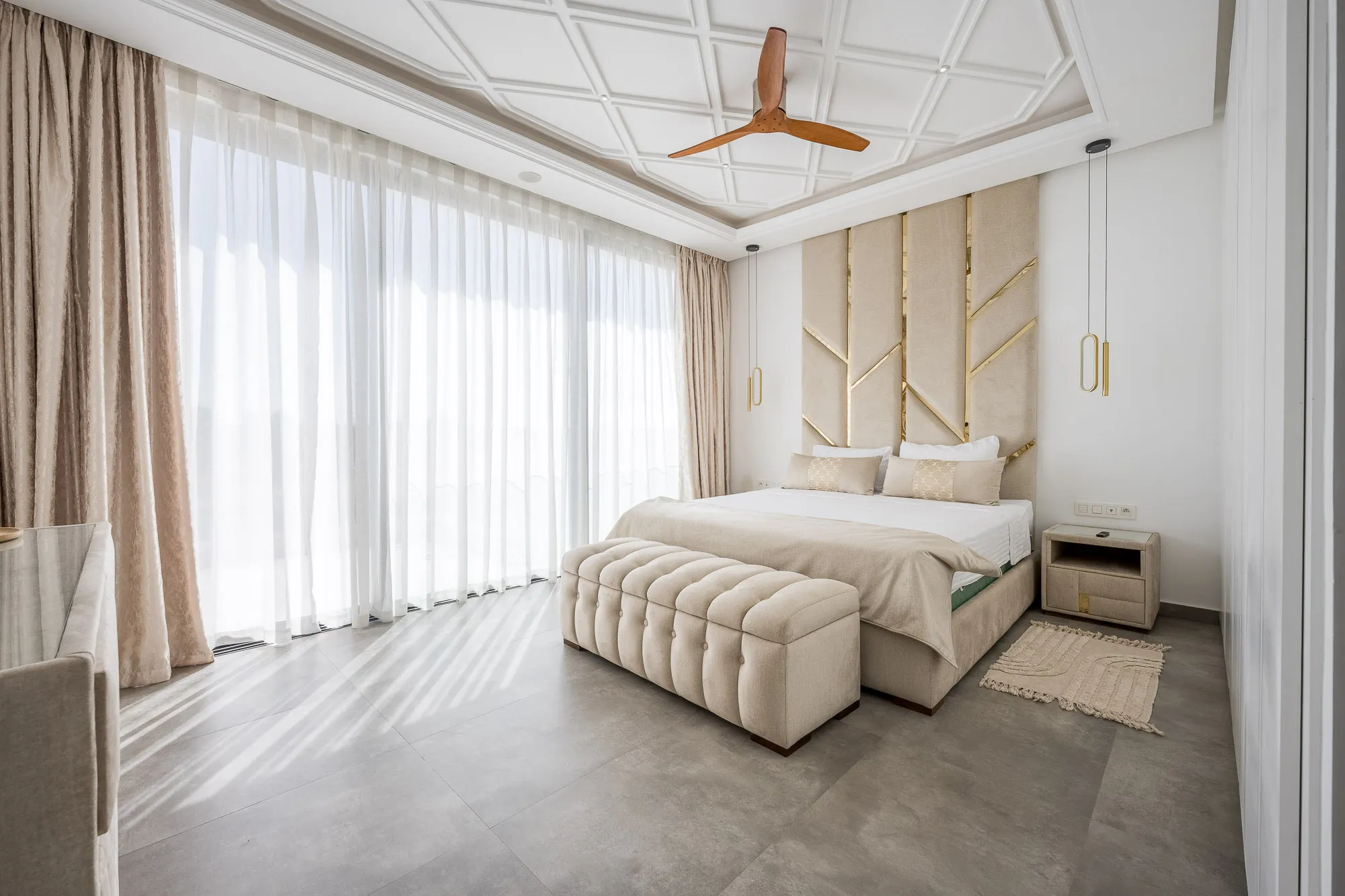 Villa Daphne, private villa rental at Amelkis Golf, Marrakech: bright bedroom with padded headboard and tufted bench