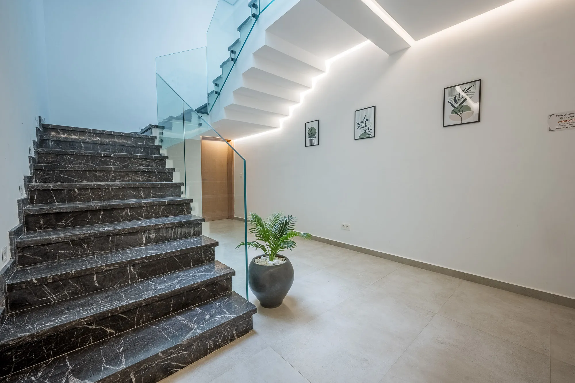 Villa Daphne, private villa rental at Amelkis Golf, Marrakech: marble staircase with glass balustrade