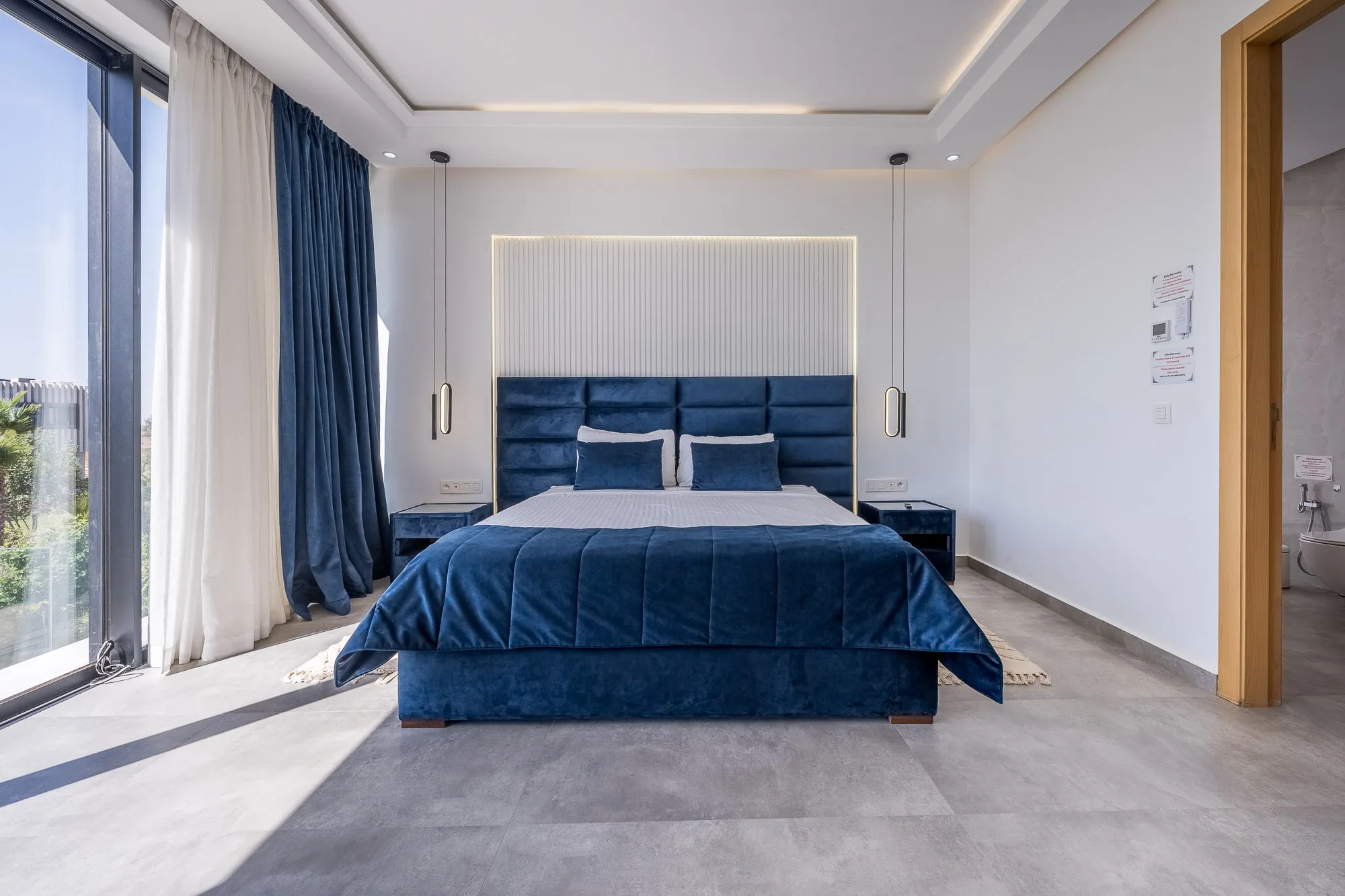 Villa Daphne, private villa rental at Amelkis Golf, Marrakech: bedroom with navy blue velvet bed