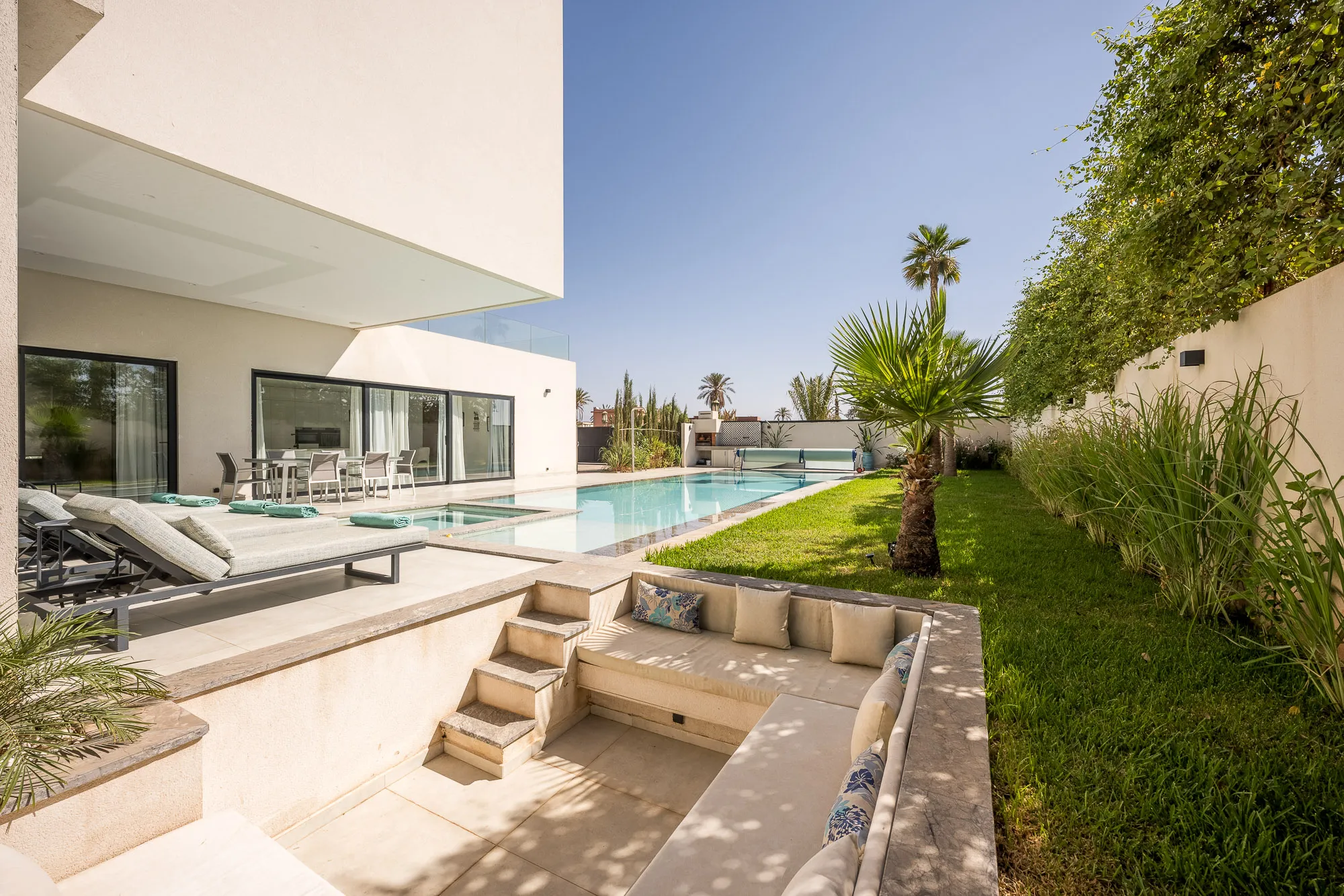 Villa Daphne, private villa rental at Amelkis Golf, Marrakech: sunken outdoor seating area beside the garden