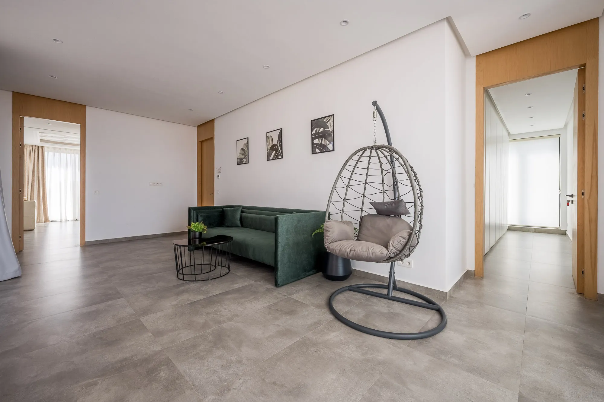 Villa Daphne, private villa rental at Amelkis Golf, Marrakech: sitting area with green sofa and hanging egg chair