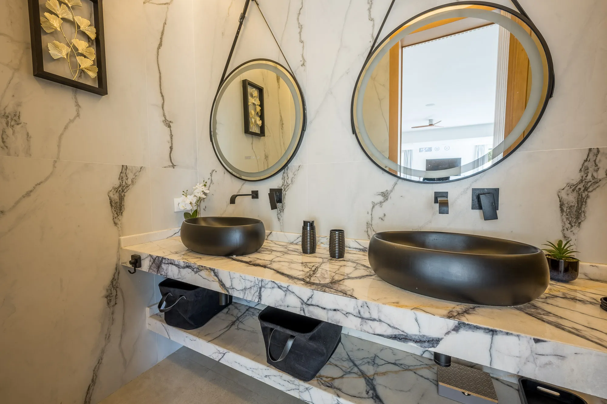 Villa Daphne, private villa rental at Amelkis Golf, Marrakech: marble bathroom with two round mirrors and black basins
