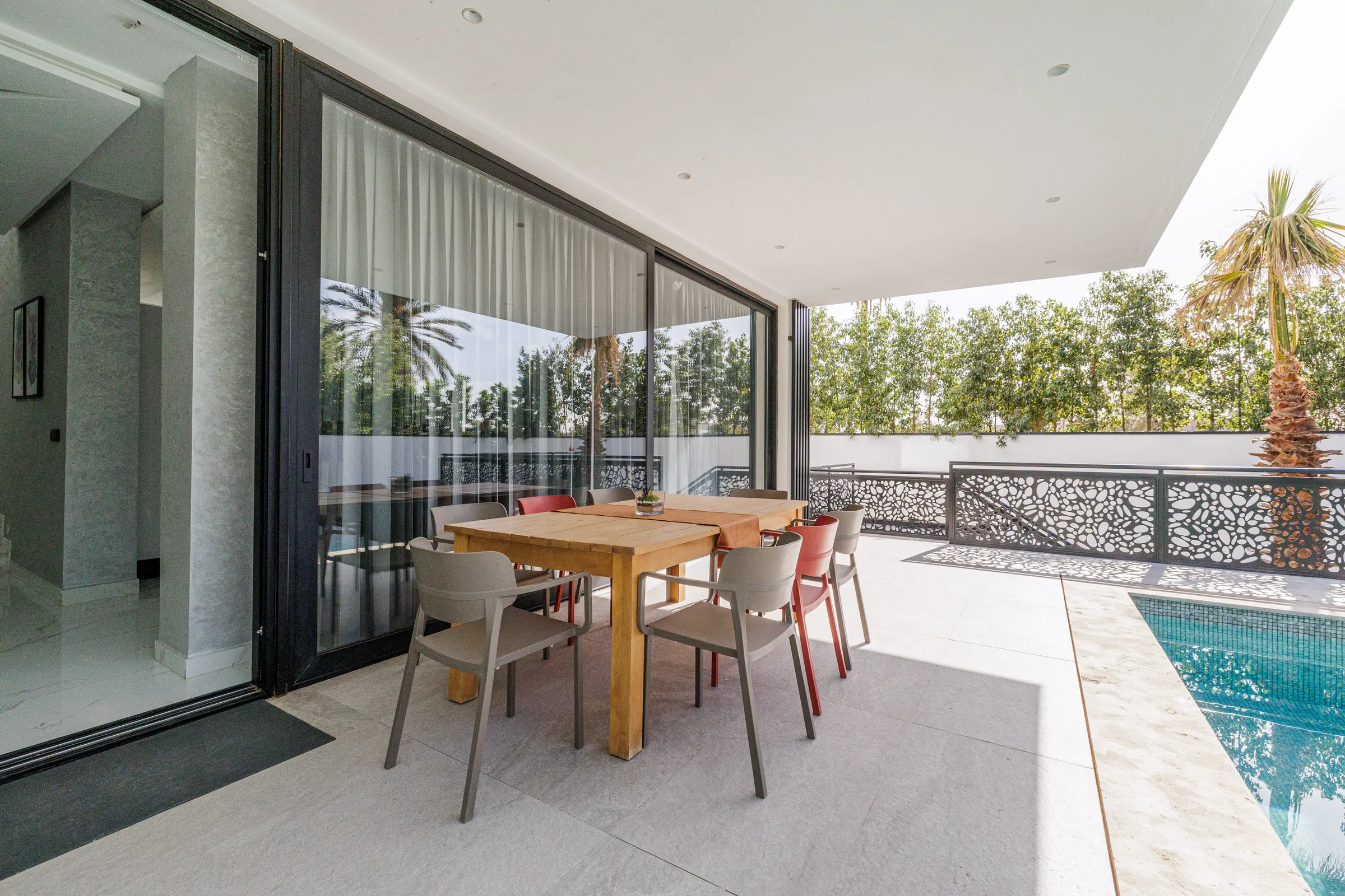 Villa Nefeli, private villa rental at Amelkis Golf, Marrakech: covered terrace with dining table by the pool