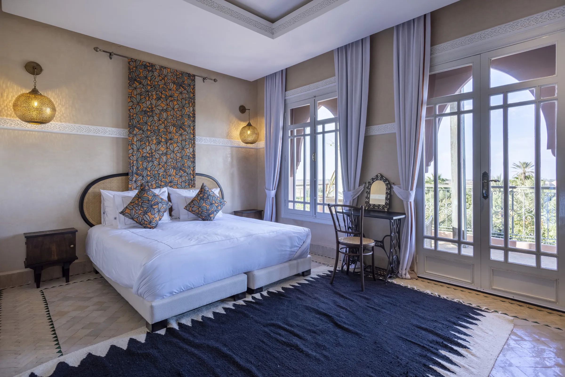 Villa Nyx, private villa rental on the Route d'Amizmiz, Marrakech: bedroom with dressing table and French windows