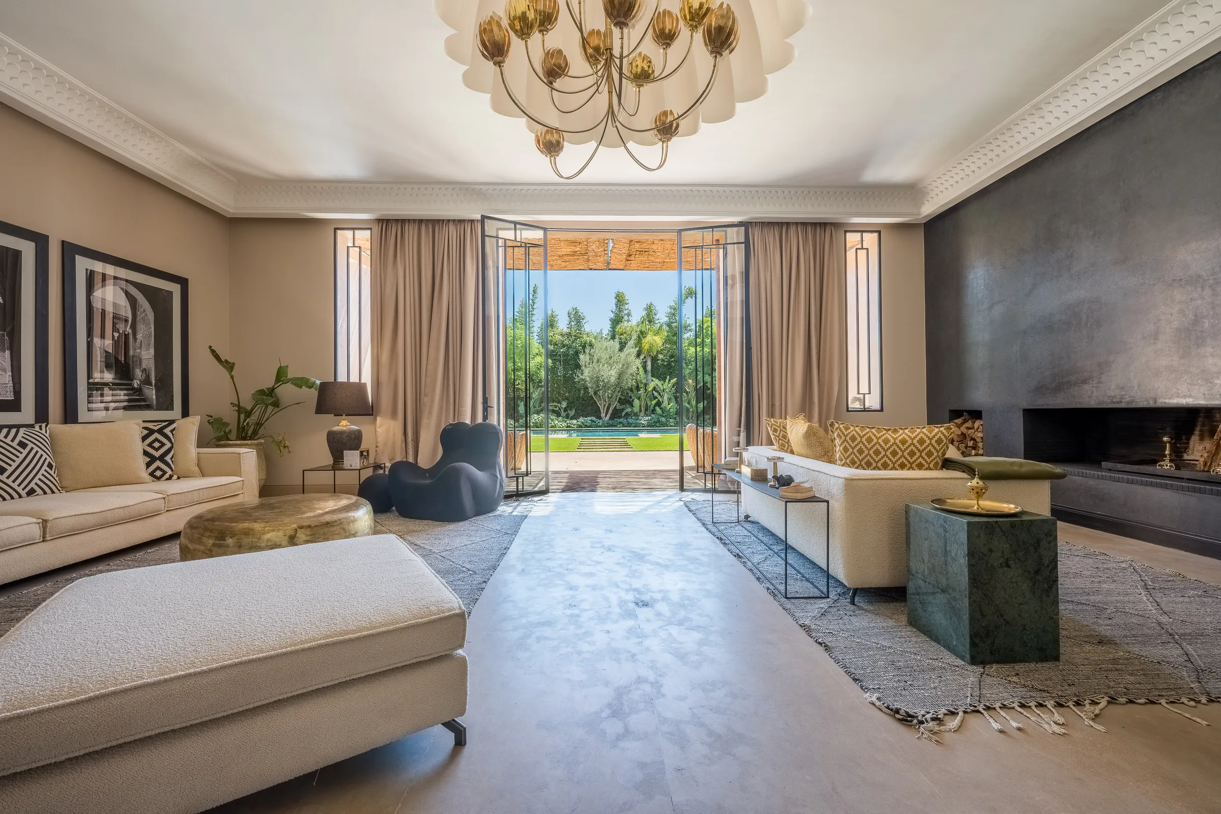 Villa Elara, private villa rental on the Route de Ouarzazate, Marrakech: living room with fireplace opening onto the garden