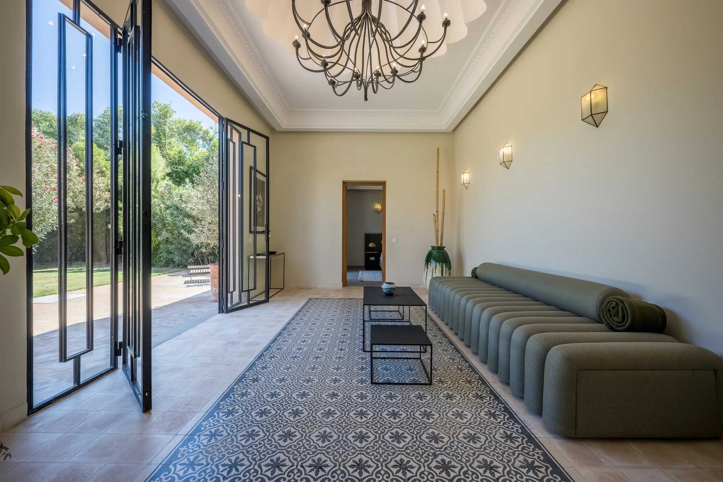 Villa Elara, private villa rental on the Route de Ouarzazate, Marrakech: lounge with green sofa opening onto the garden