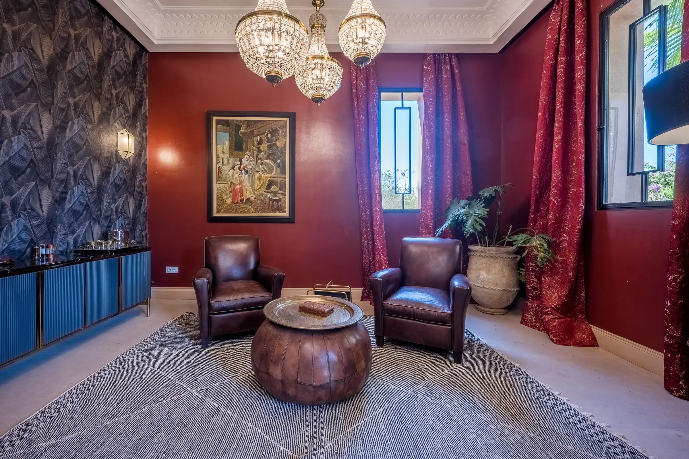 Villa Elara, private villa rental on the Route de Ouarzazate, Marrakech: red salon with leather club armchairs