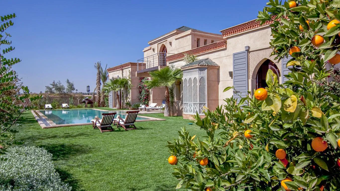 Villa Myrto, private villa rental at Amelkis Golf, Marrakech: swimming pool and lawn with an orange tree