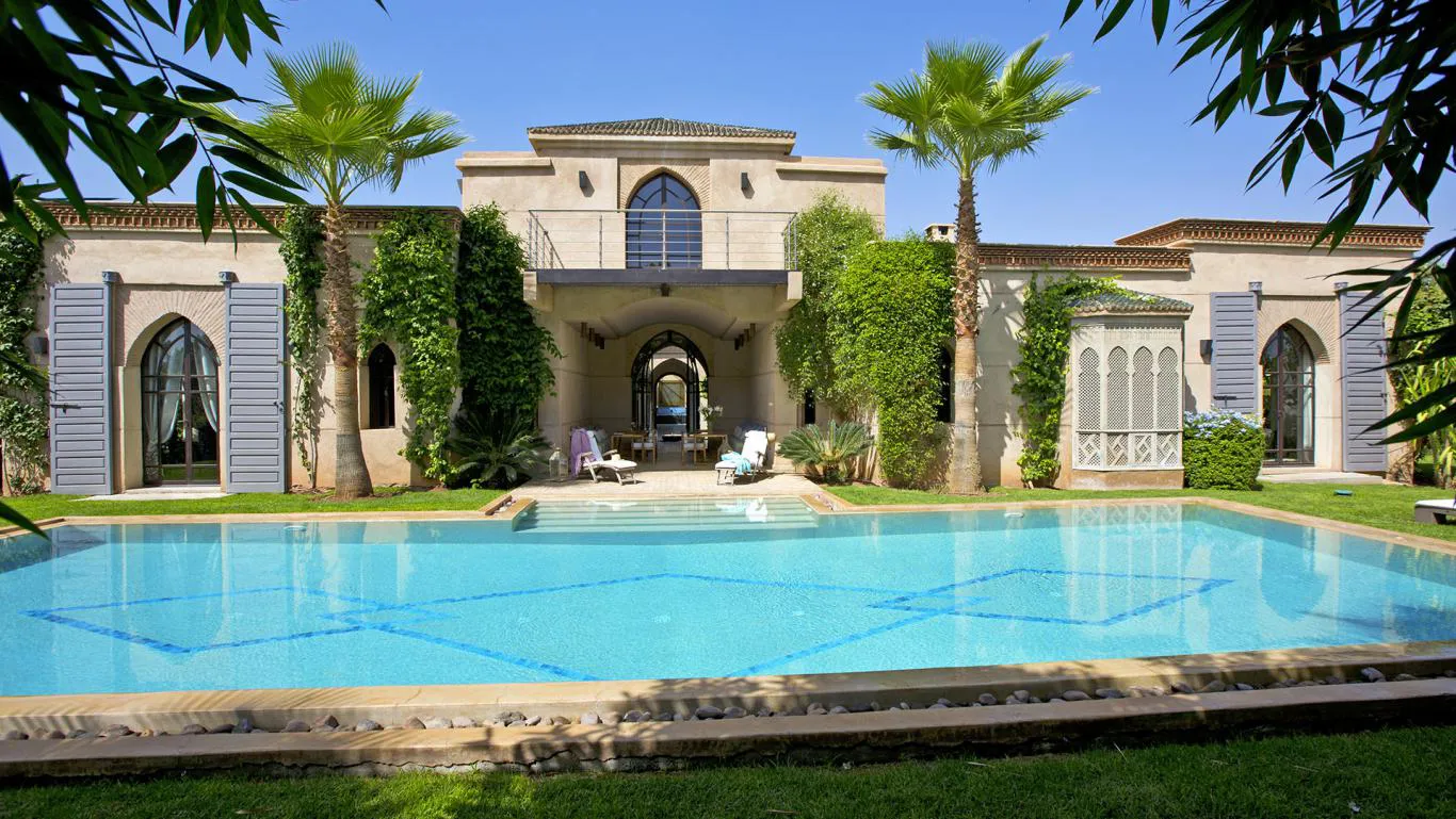 Villa Myrto, private villa rental at Amelkis Golf, Marrakech: swimming pool in front of the villa's arched facade