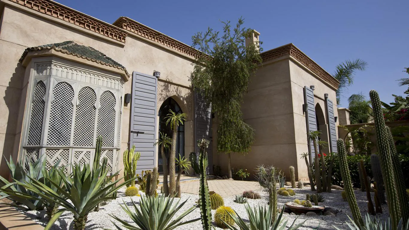 Villa Myrto, private villa rental at Amelkis Golf, Marrakech: facade with carved wooden bay window and cactus garden