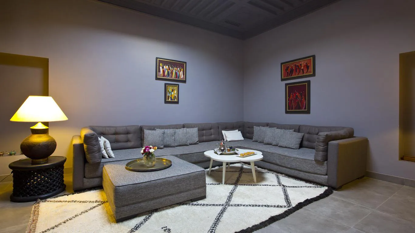 Villa Myrto, private villa rental at Amelkis Golf, Marrakech: lounge with grey corner sofa and Berber rug
