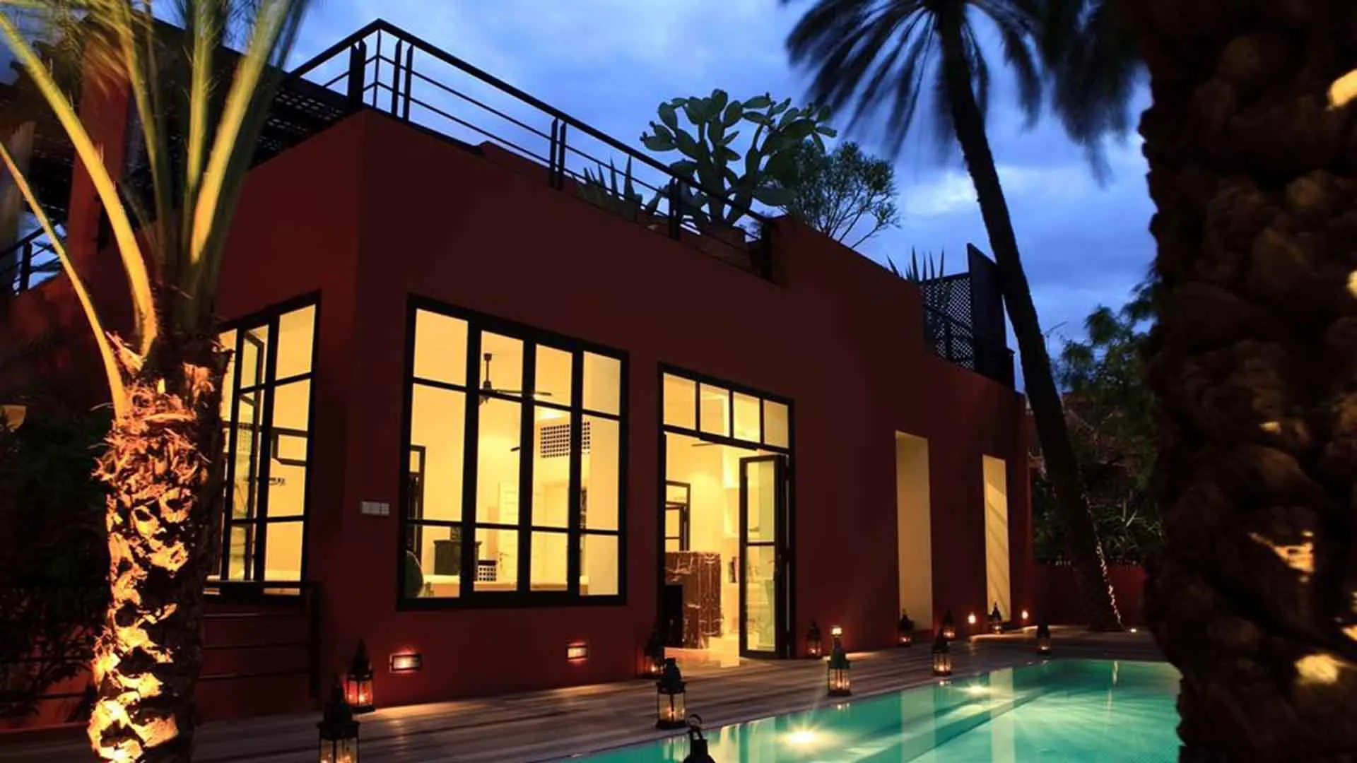 Villa Leda, private villa rental near Majorelle, Marrakech: villa and pool lit up at dusk