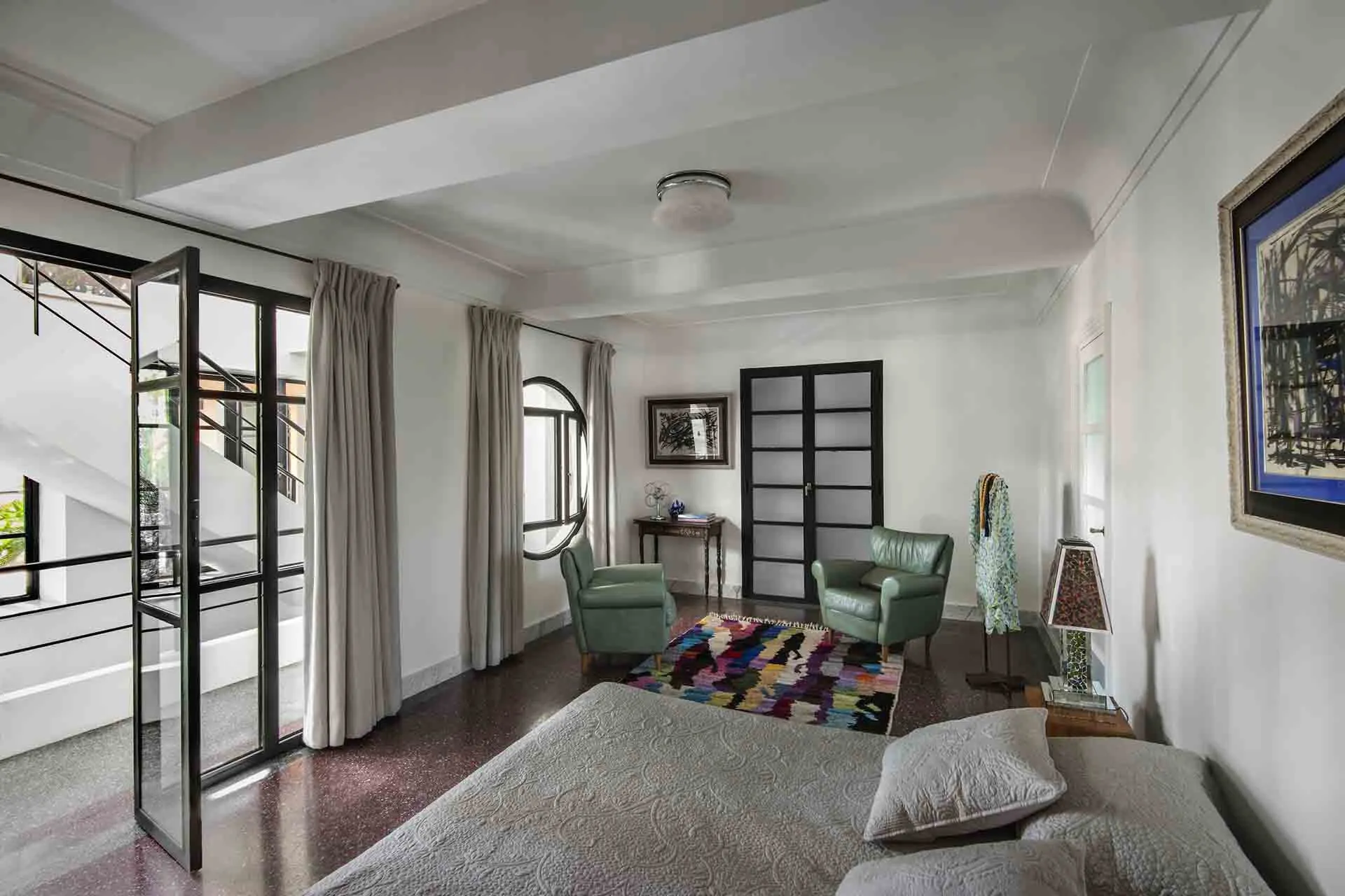 Villa Leda, private villa rental near Majorelle, Marrakech: bedroom with colourful rug and armchairs