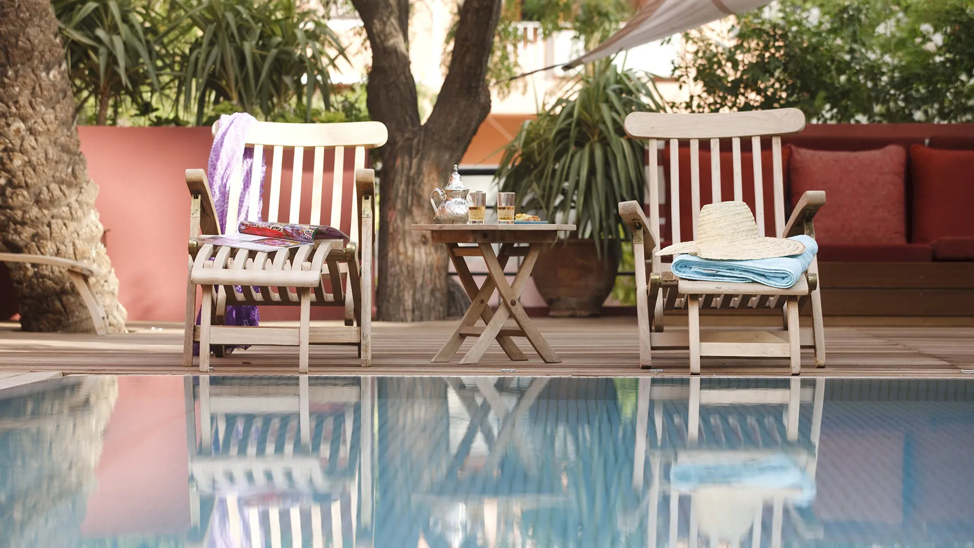 Villa Leda, private villa rental near Majorelle, Marrakech: wooden deckchairs beside the pool