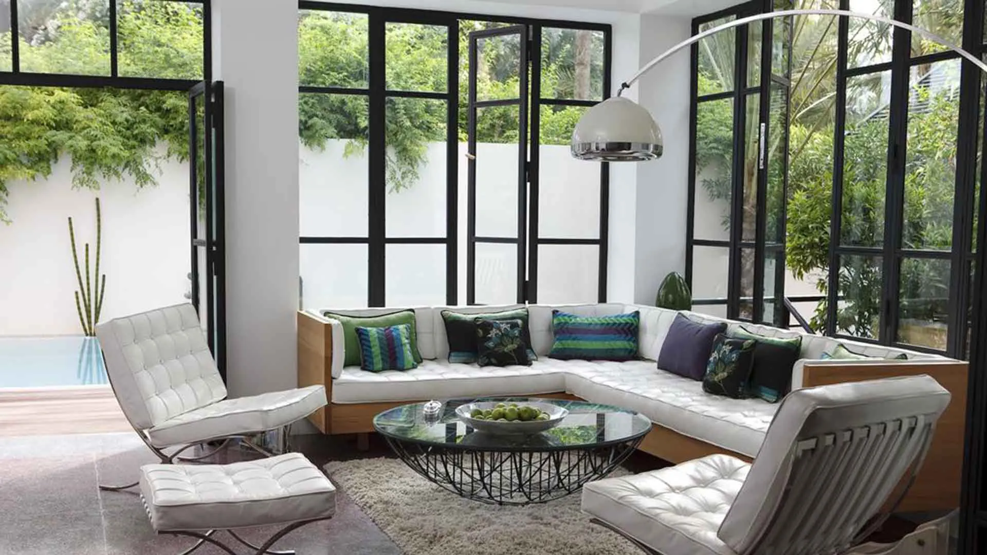 Villa Leda, private villa rental near Majorelle, Marrakech: living room with white leather armchairs and garden views