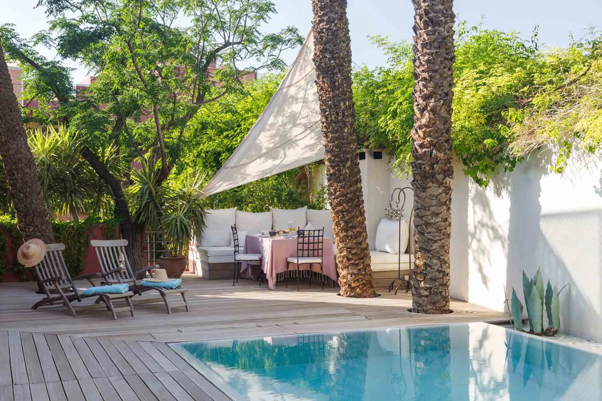 Villa Leda, private villa rental near Majorelle, Marrakech: pool with wooden deck, shade sail and garden