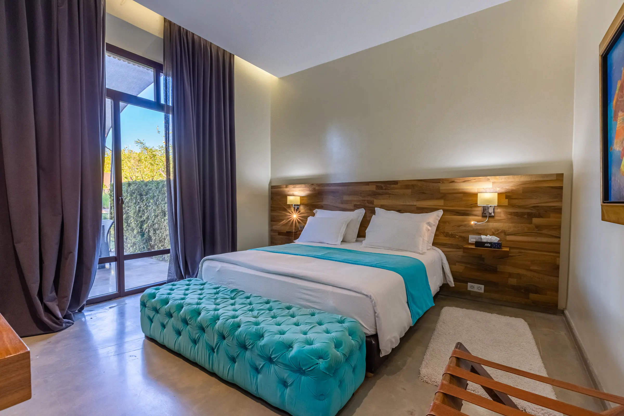Villa Ismene, private villa rental at Samanah Golf, Marrakech: bedroom with turquoise bench and wooden headboard