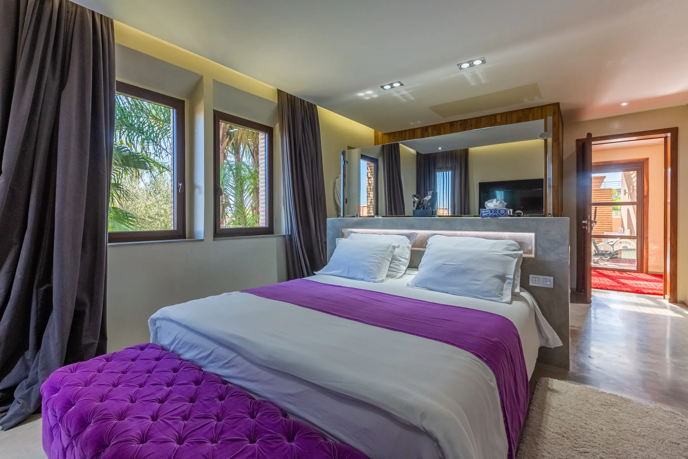 Villa Ismene, private villa rental at Samanah Golf, Marrakech: bedroom with purple bench and garden windows