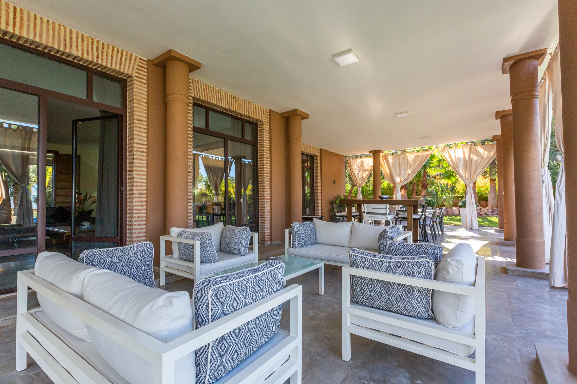 Villa Ismene, private villa rental at Samanah Golf, Marrakech: covered terrace lounge with outdoor sofas