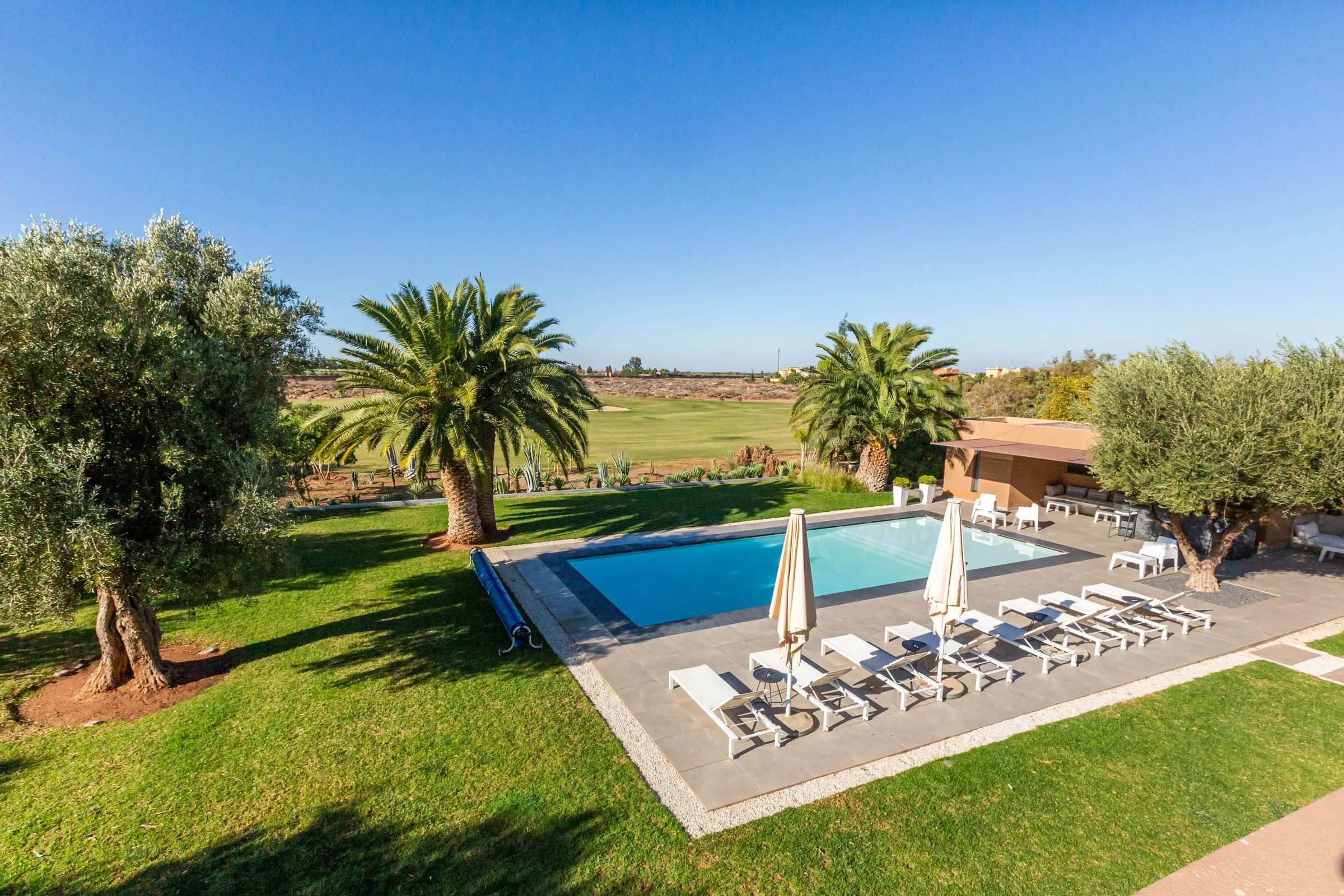 Villa Ismene, private villa rental at Samanah Golf, Marrakech: pool and sun loungers overlooking the golf course