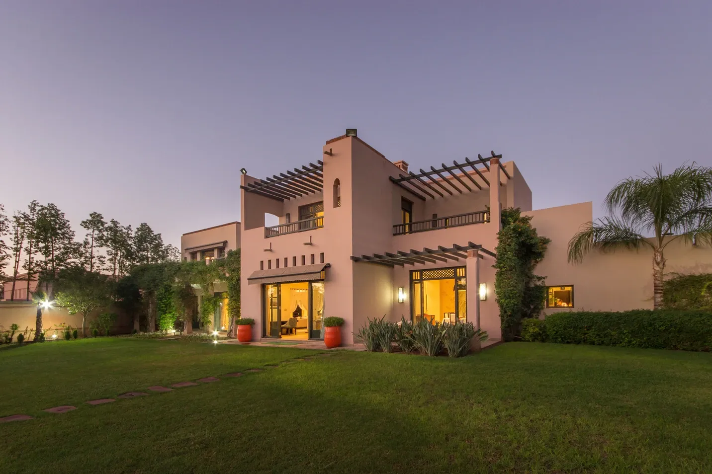 Villa Kyma, private villa rental at the Four Seasons Resort, Marrakech: villa facade and lawn at dusk