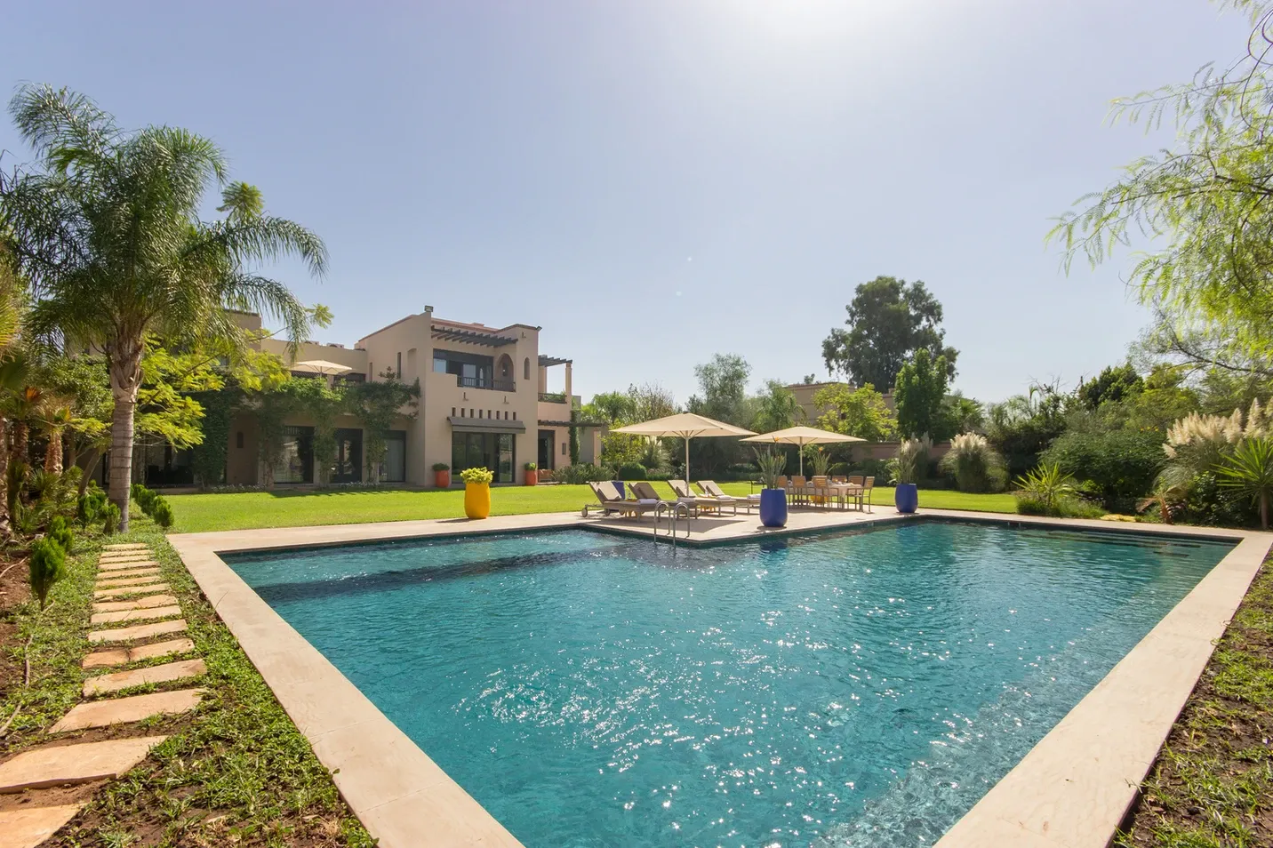 Villa Kyma, private villa rental at the Four Seasons Resort, Marrakech: swimming pool and lawn in front of the villa